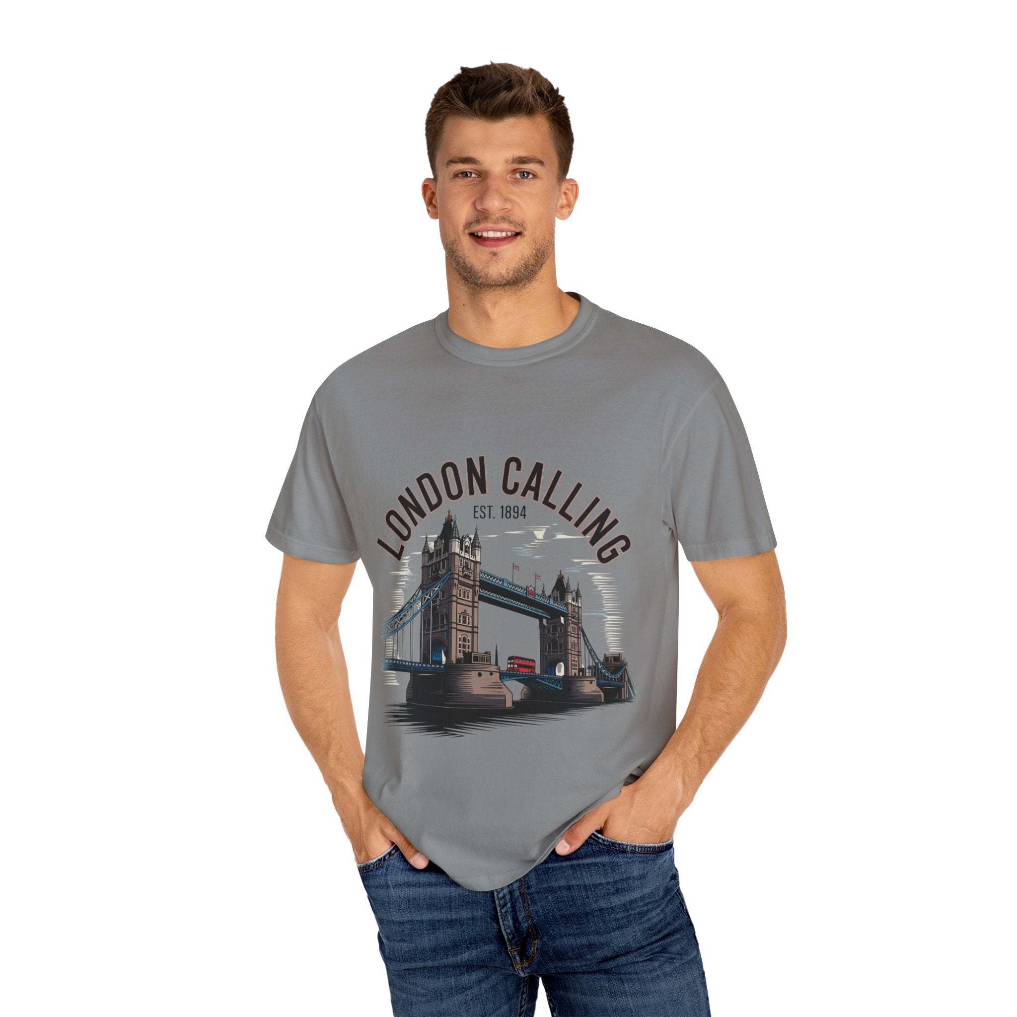Man wearing grey London Calling Travel T-shirt with Tower Bridge graphic and text on front