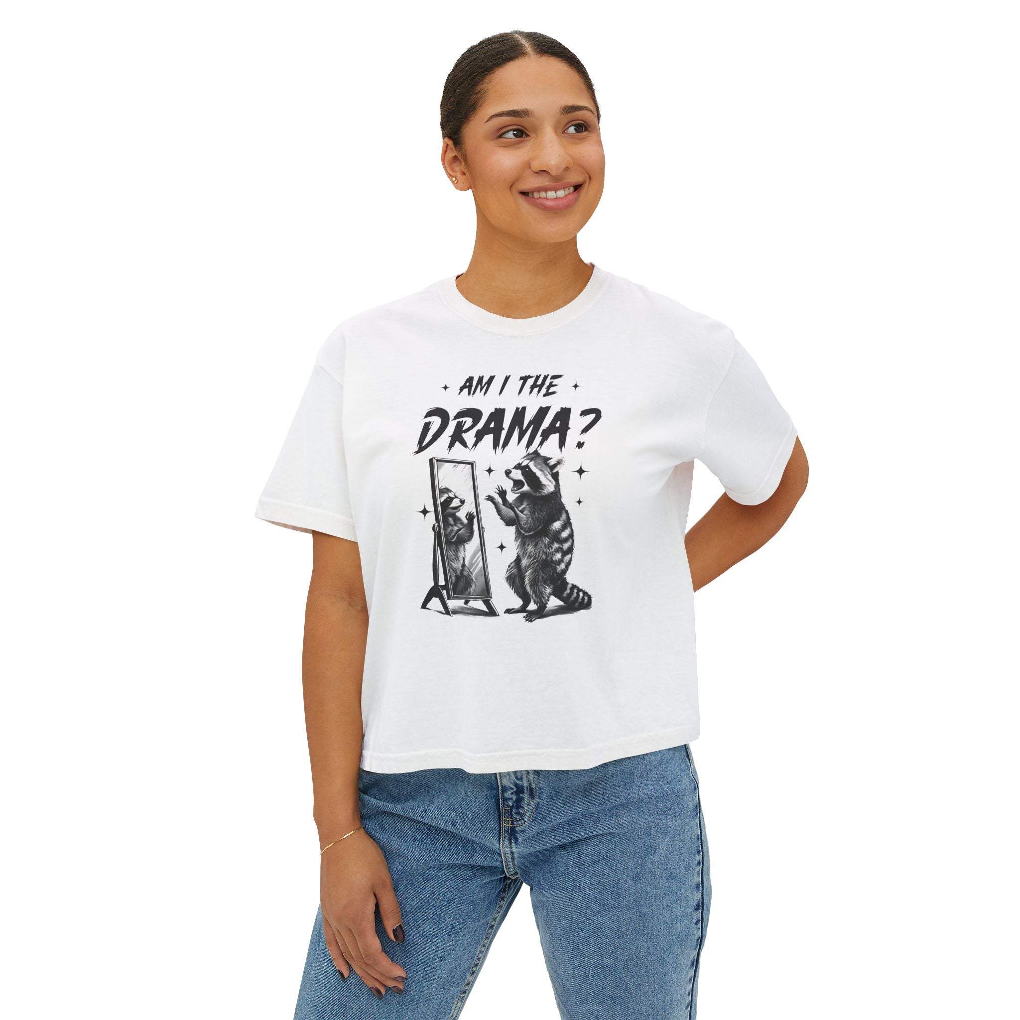 Woman wearing white Boxy Tee with "Am I The Drama?" text and raccoon graphic, paired with jeans