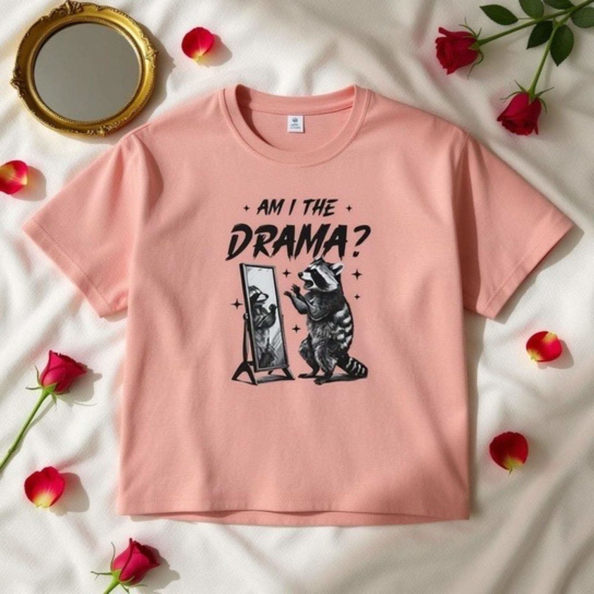 Pink women's boxy tee with "Am I The Drama?" text and raccoon graphic, vintage style cotton shirt