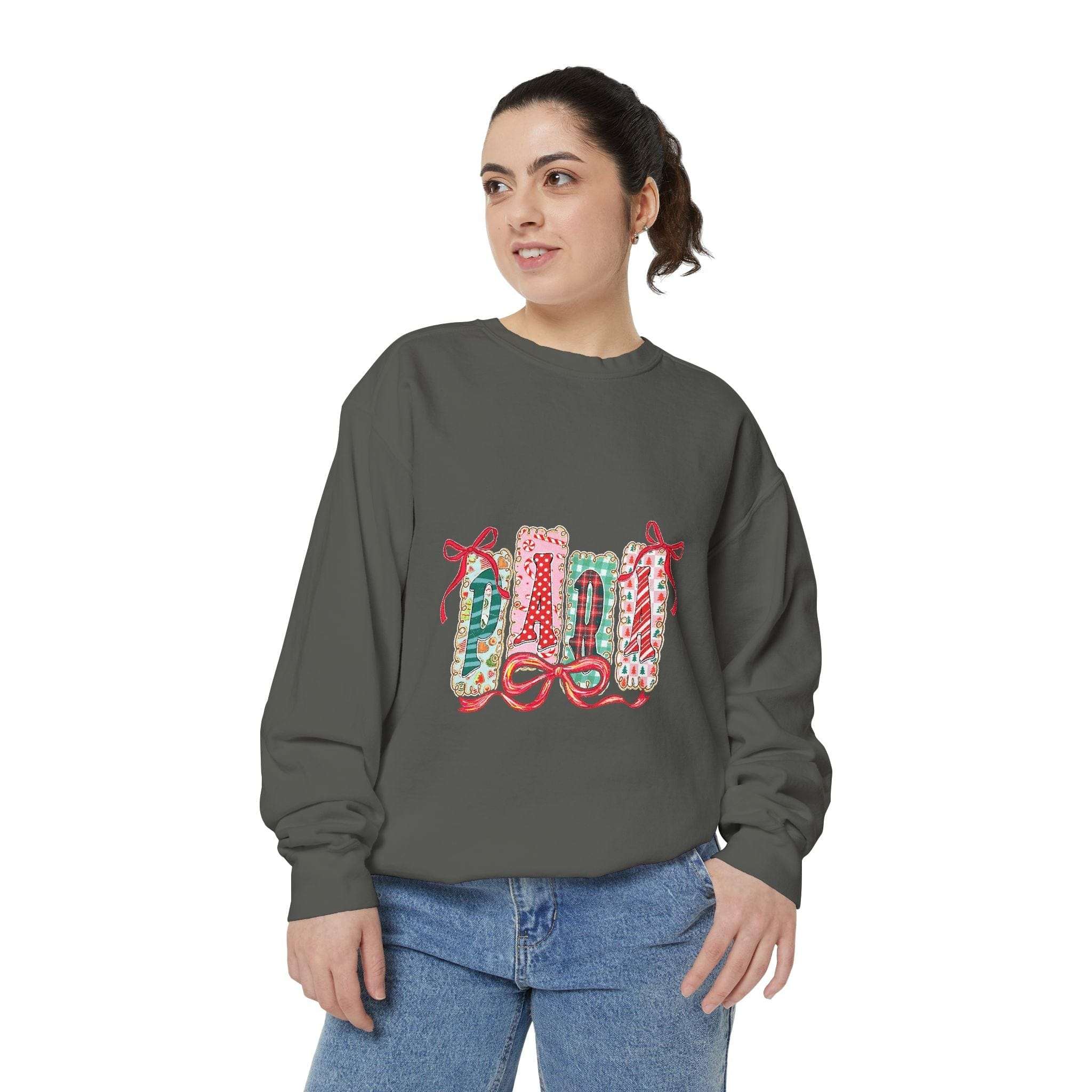 Woman wearing a gray sweatshirt preppy Christmas design with festive gift wrap graphics and red bows