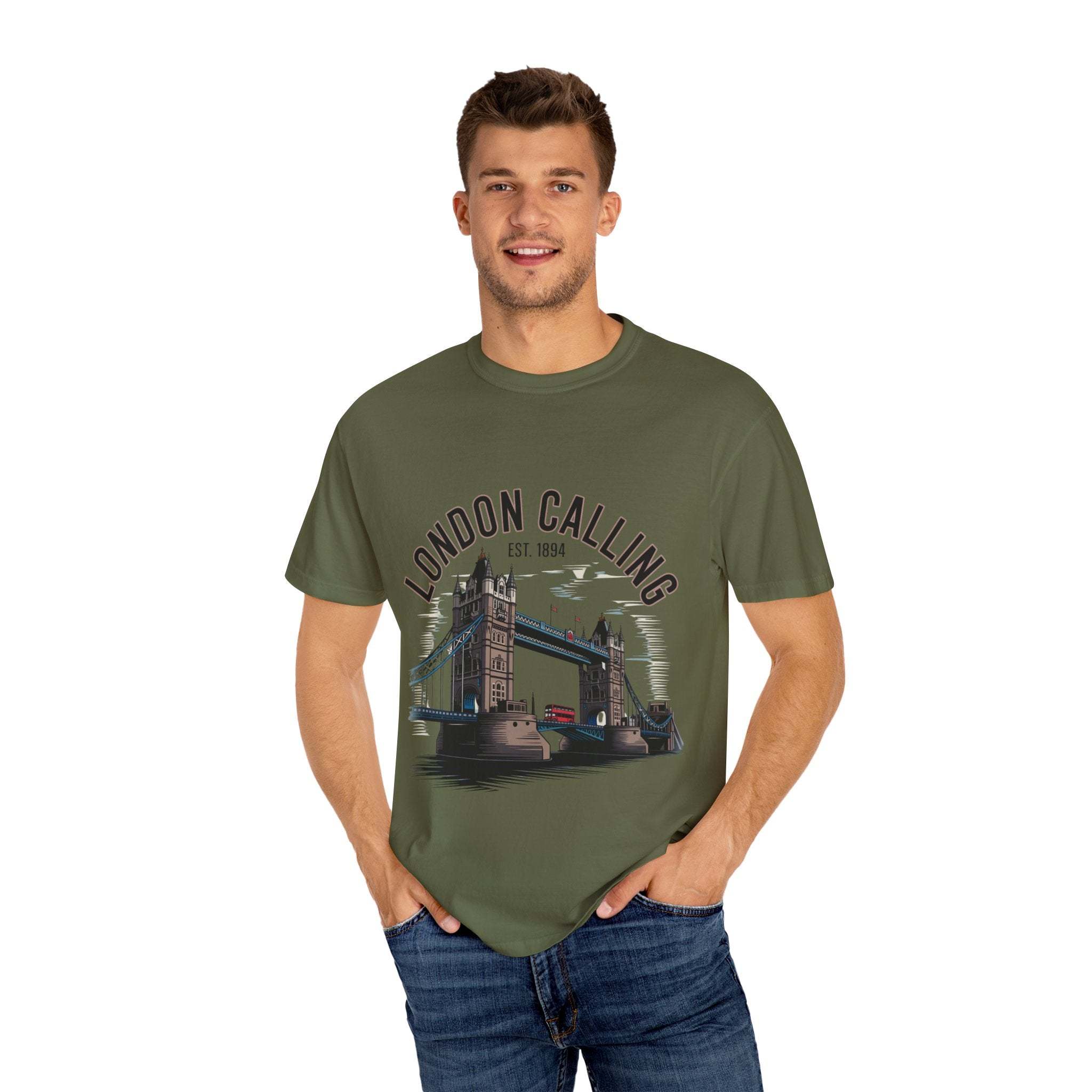 Man wearing olive green London Calling Travel T-shirt with London Bridge graphic, casual unisex cotton tee