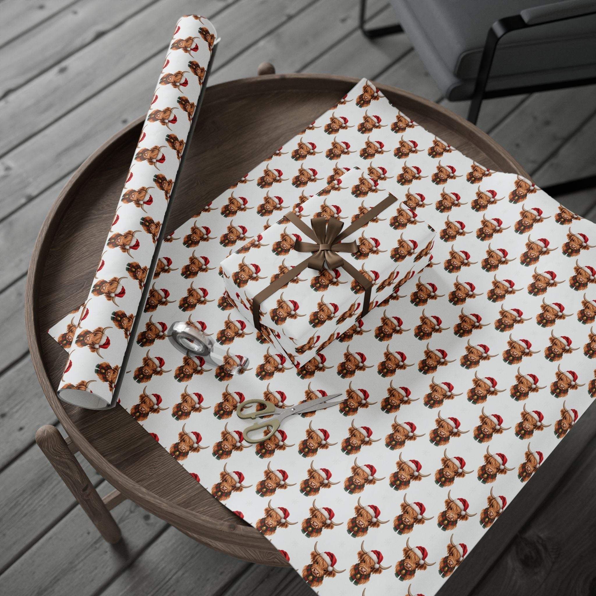Gift wrapping papers with Santa Highland Cows design on thick fine art paper roll on wooden table