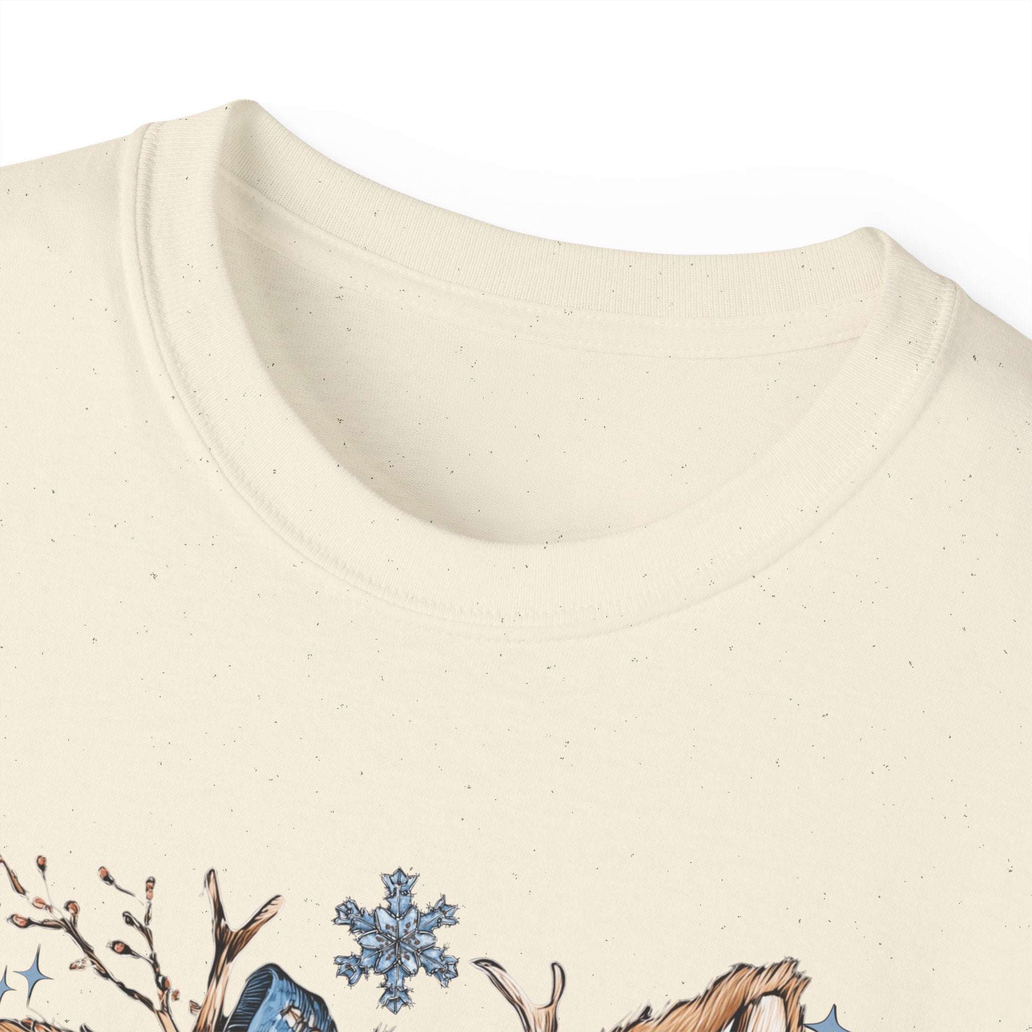 White t-shirt with retro patchwork reindeer design wearing blue scarf and surrounded by snowflakes