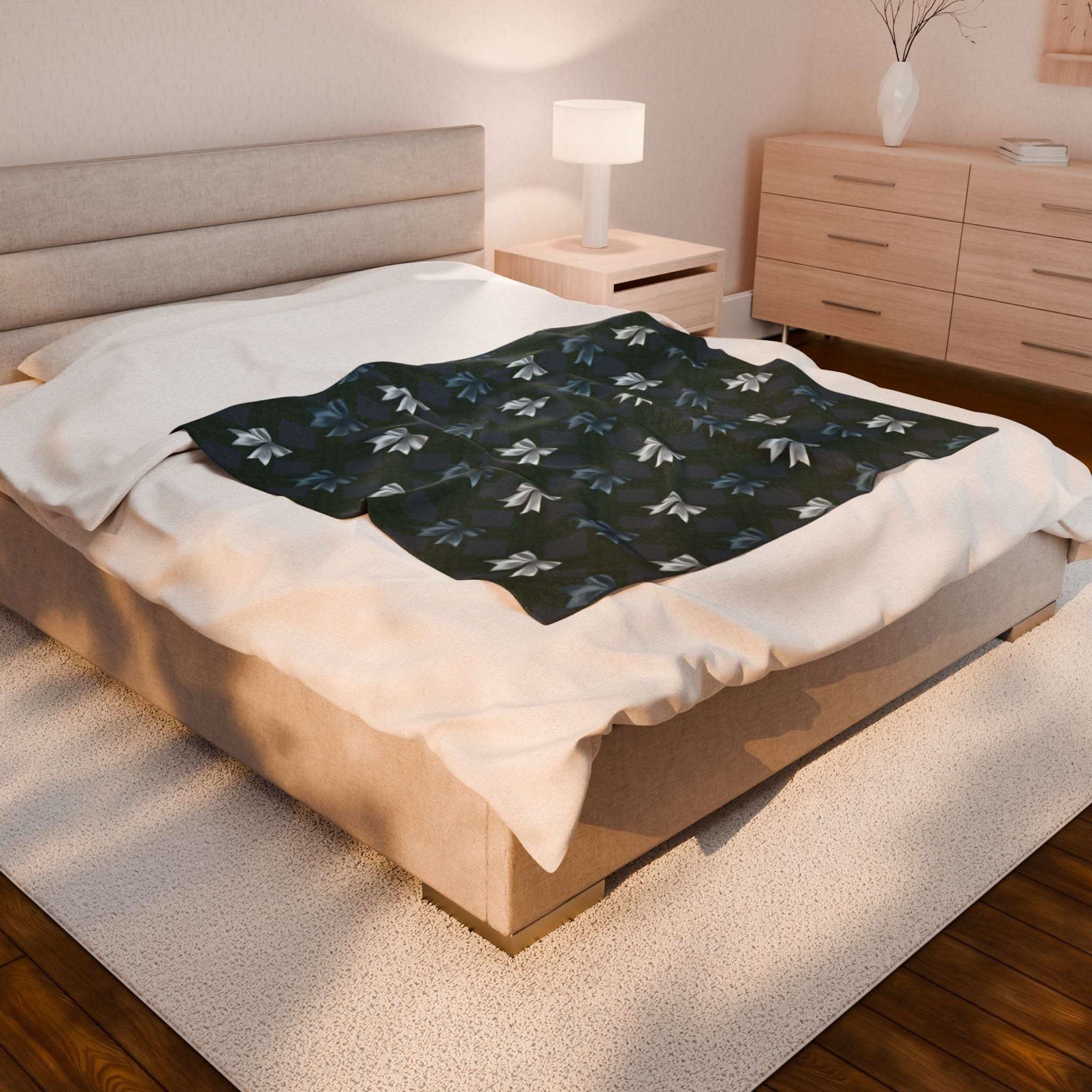 Velveteen Plush Blanket with Winter Coquette Bows design on bed in cozy bedroom setting