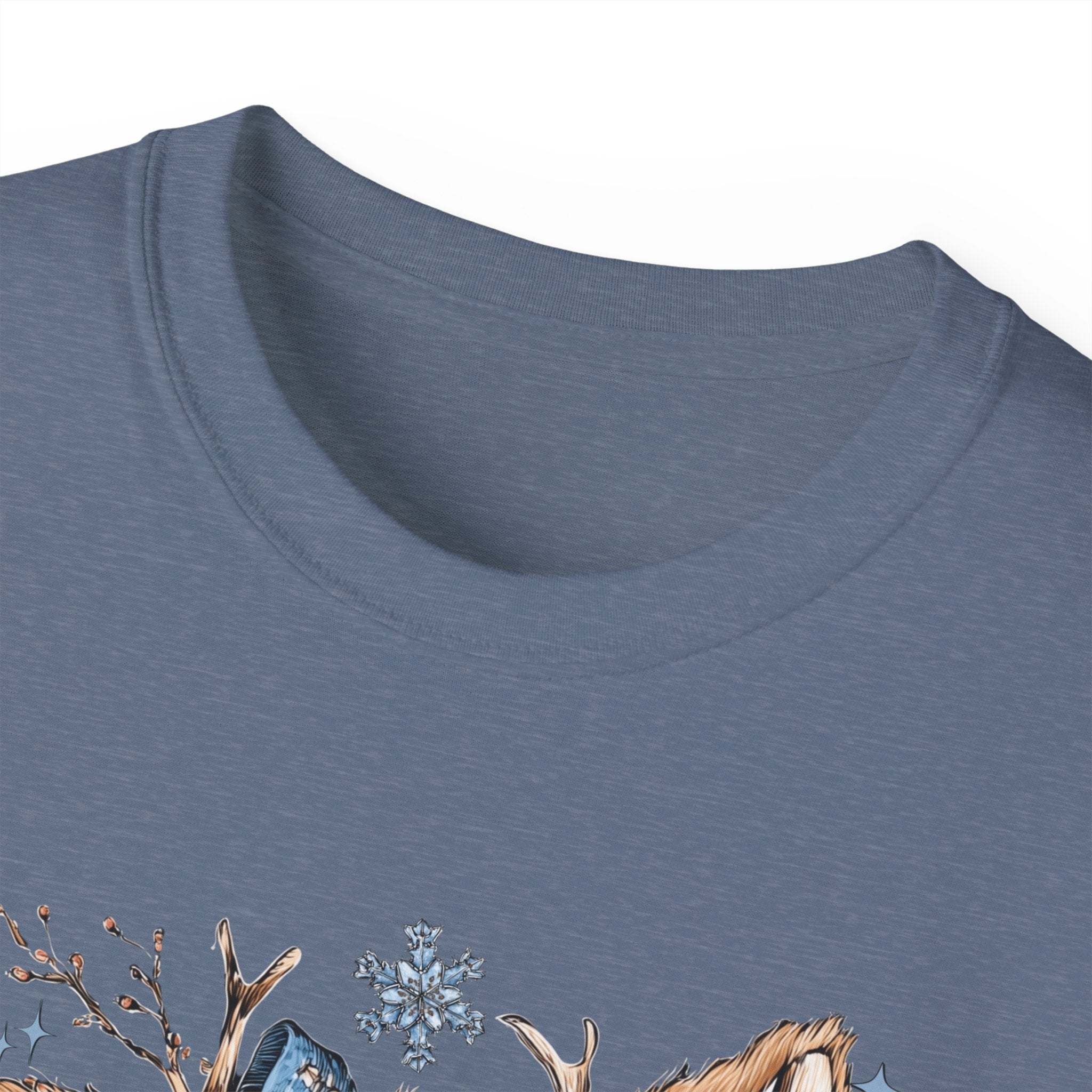 Close-up of blue Retro Patchwork Reindeer T-shirt with festive design and snowflakes