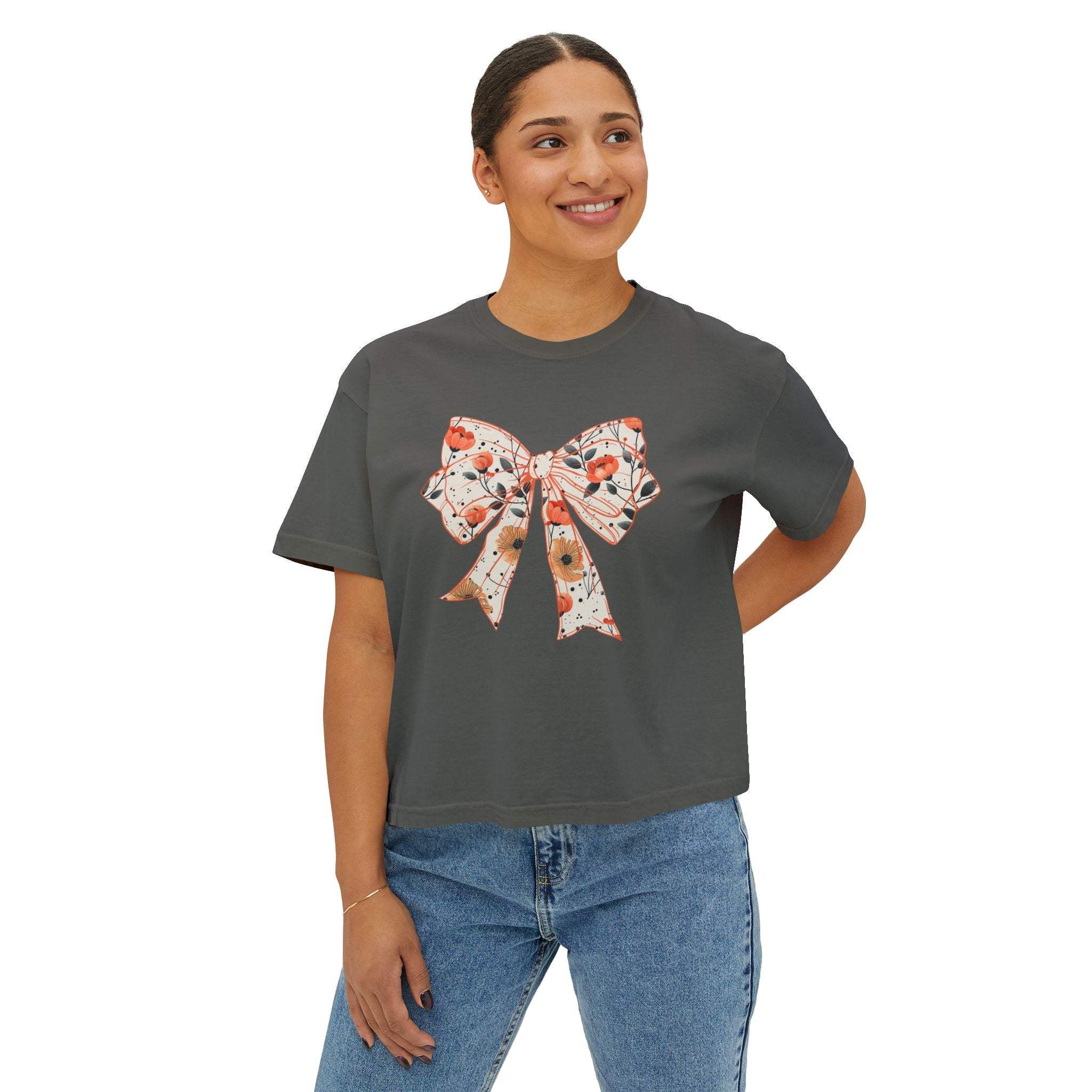 Womens tee with floral coquette bow design in vintage pigment dye colors, boxy fit and cropped seamless body.