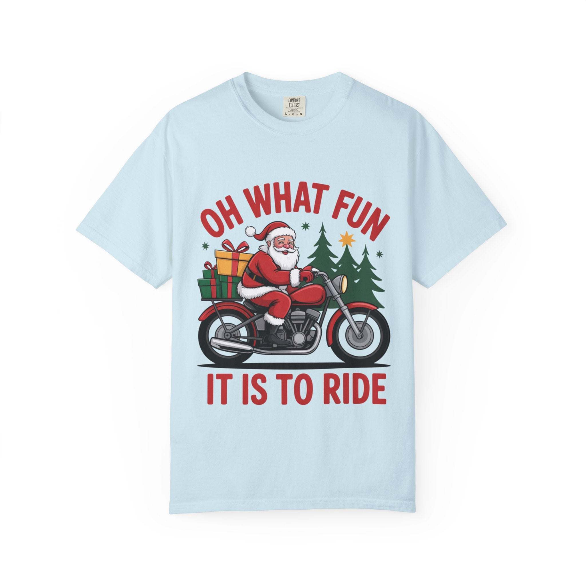 Light blue t-shirt featuring Santa on a motorcycle with gifts and Christmas trees, text "Oh What Fun It Is To Ride"