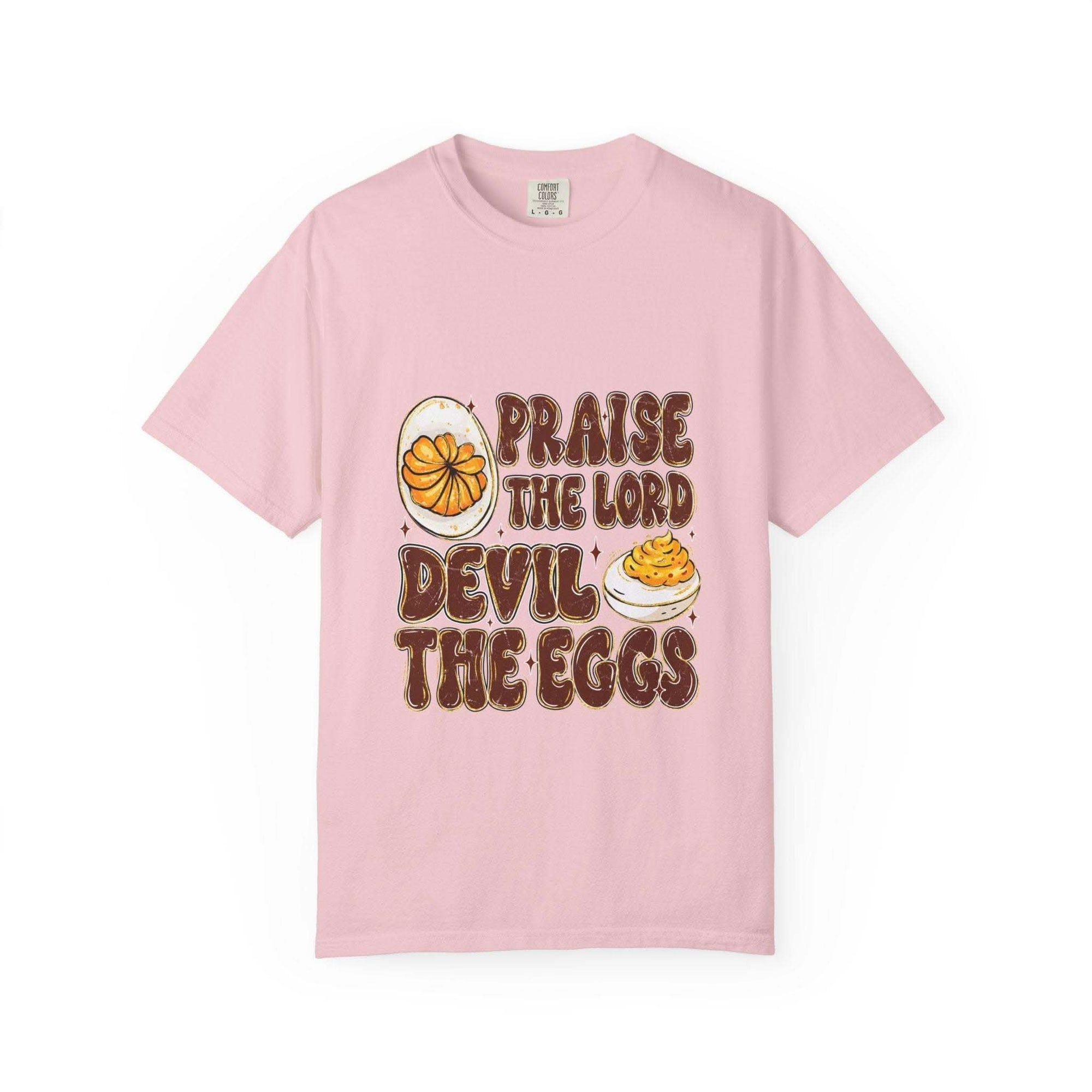 White cotton t-shirt featuring 'Praise the Lord, Devil the Eggs' design, perfect for Easter and Christian apparel.
