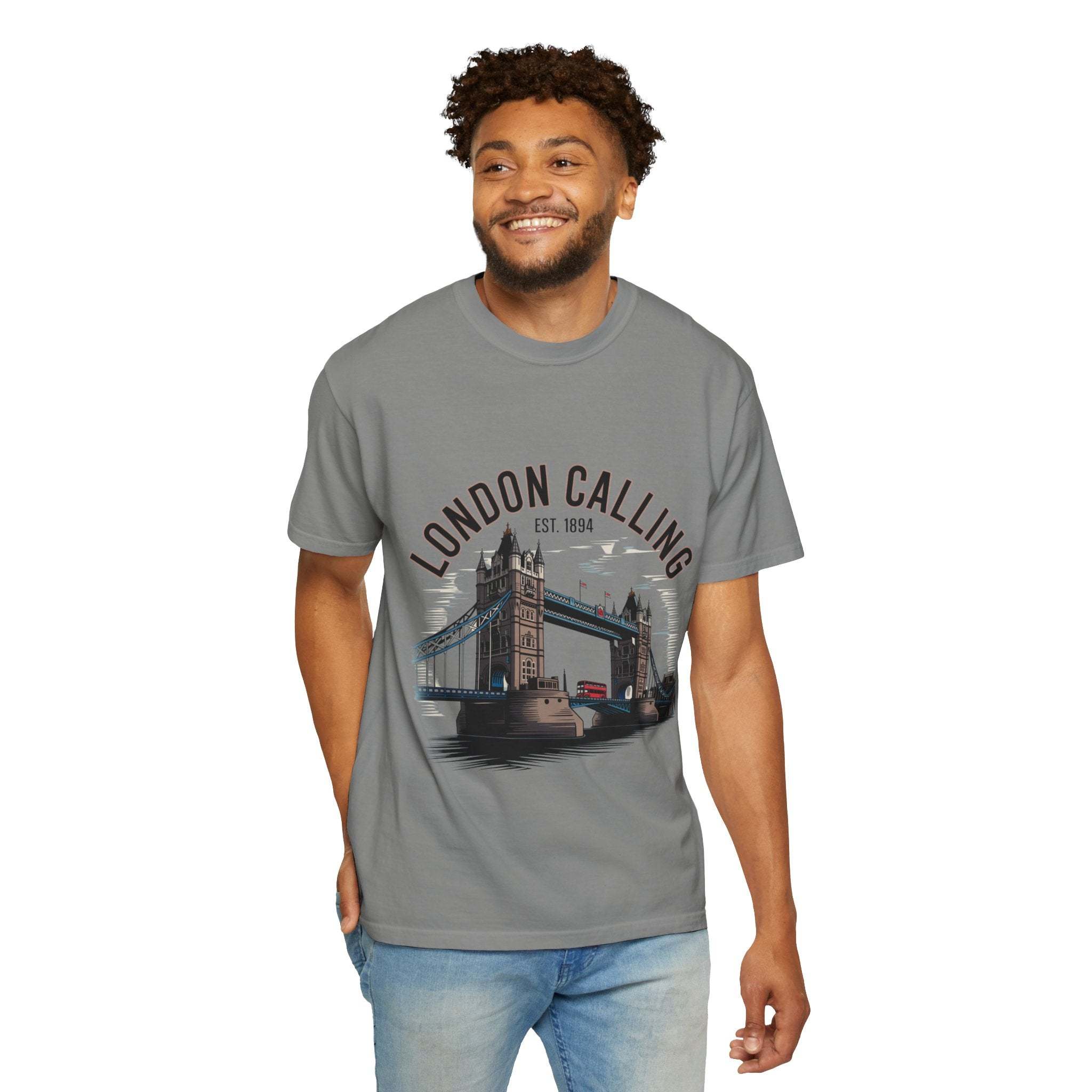 Man wearing gray London Calling Travel T-shirt with Tower Bridge graphic and text on front