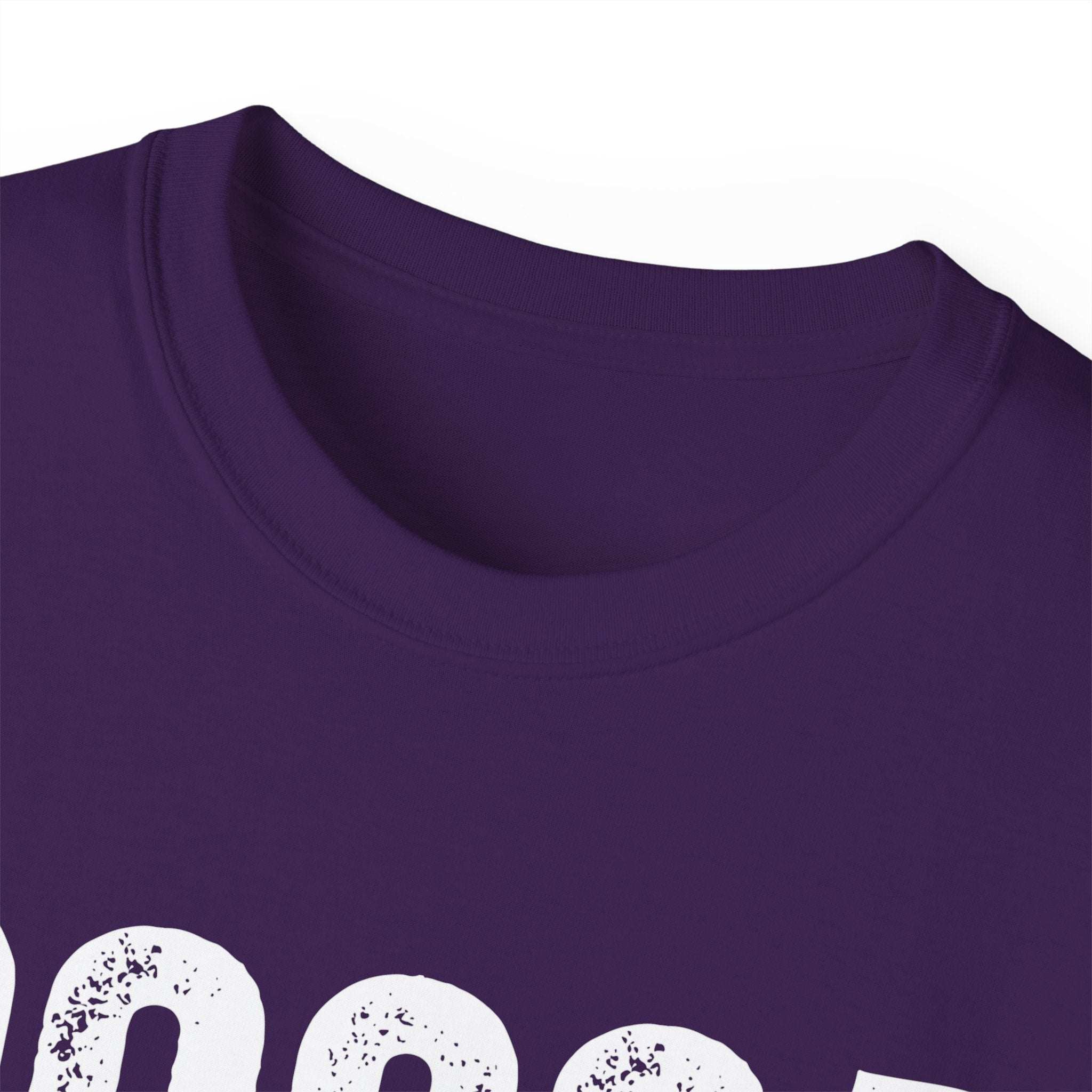 Close-up of distressed Cocoa Cutie Tee in purple with vintage white print and eco-friendly cotton fabric