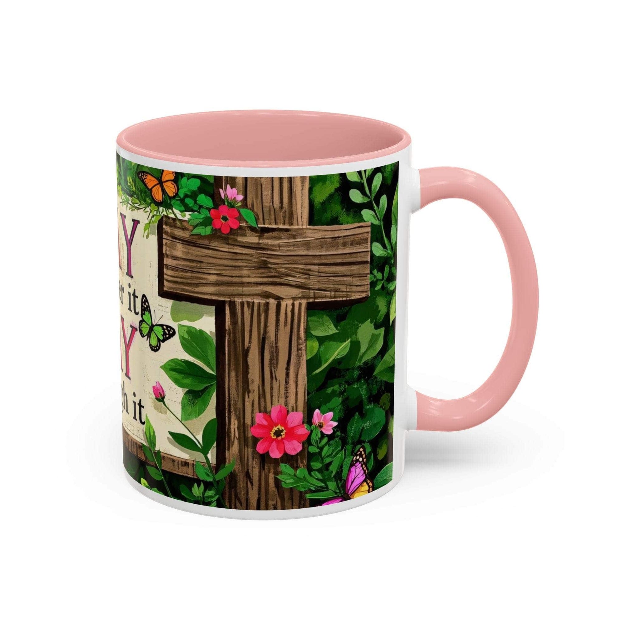 Mug with pink interior and handle, featuring a wooden cross and floral design on a white background