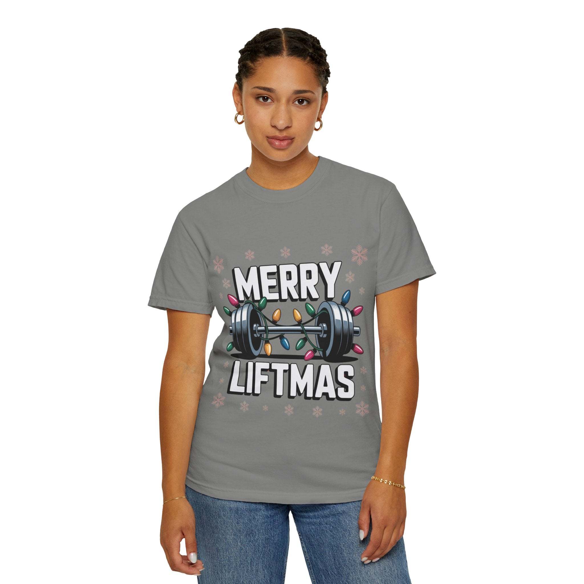 Woman wearing gray Merry Liftmas Christmas Workout T-shirt with barbell and holiday lights design