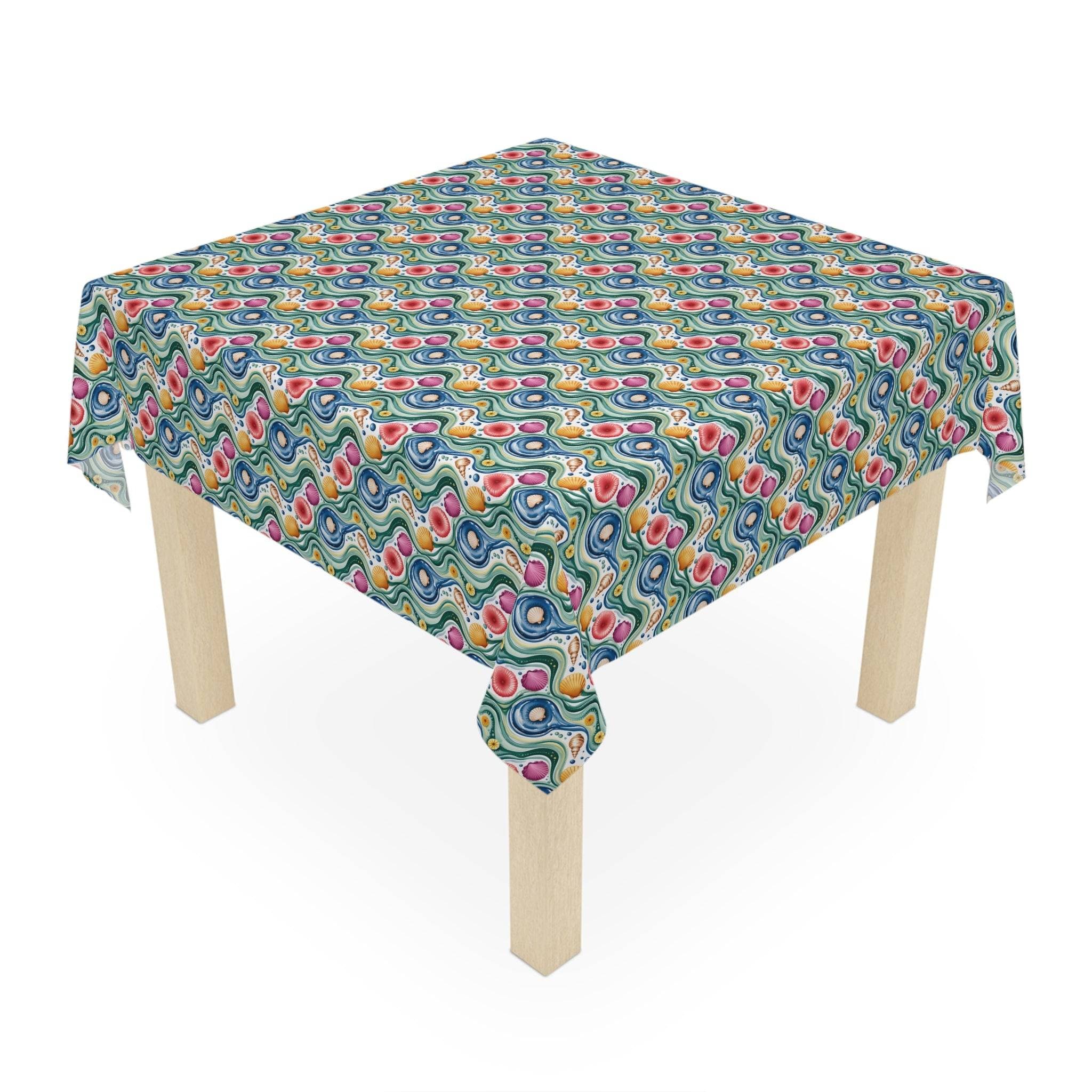 Tablecloth Coastal Shells with vibrant coastal shell pattern on square wooden table