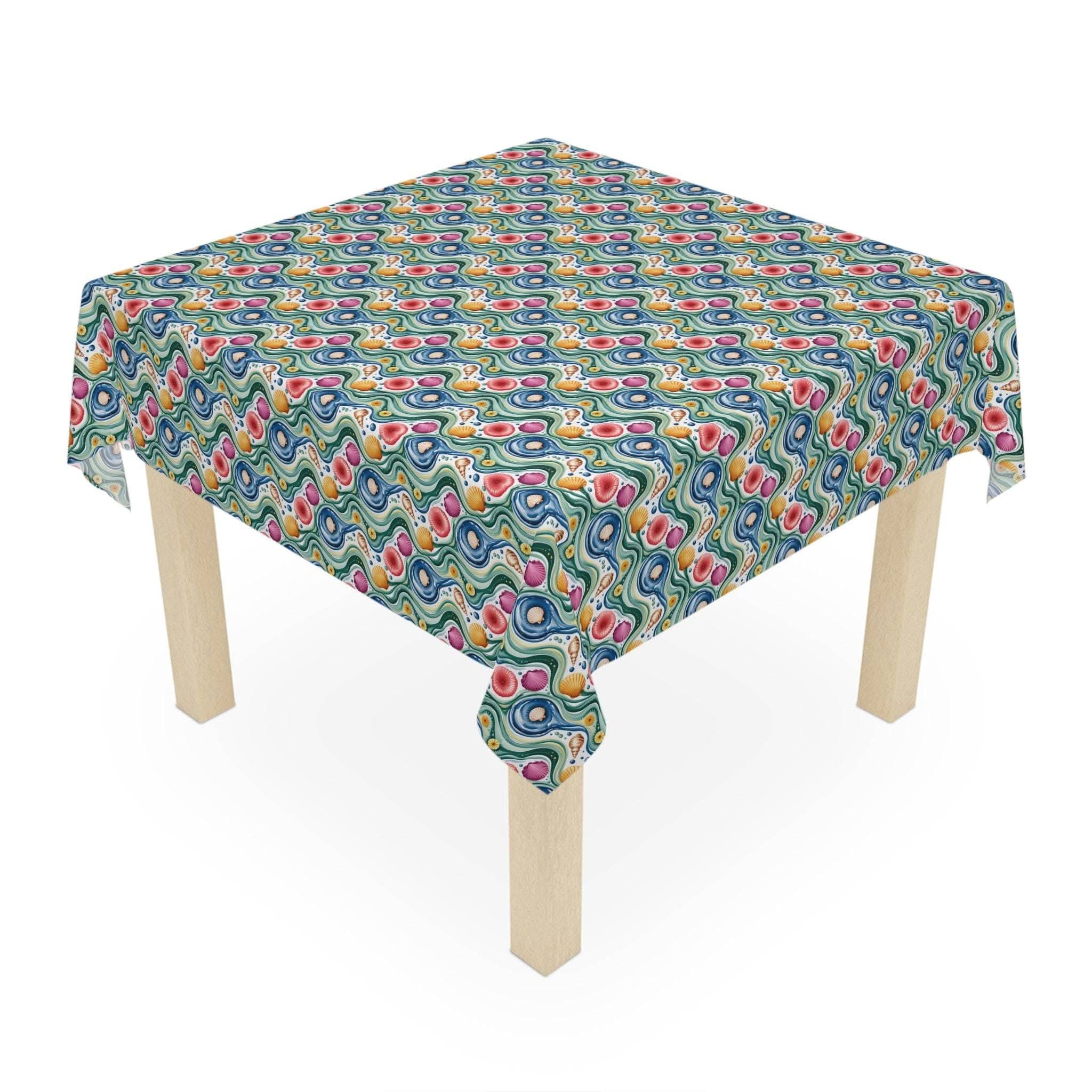 Tablecloth Coastal Shells with vibrant coastal shell pattern on square wooden table