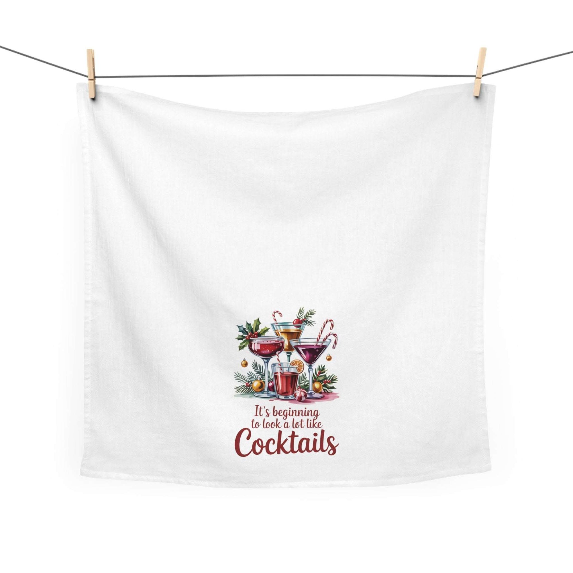 White tea towel featuring 'It's Beginning to Look a Lot Like Cocktails' text, perfect for holiday kitchen decor by Printify.