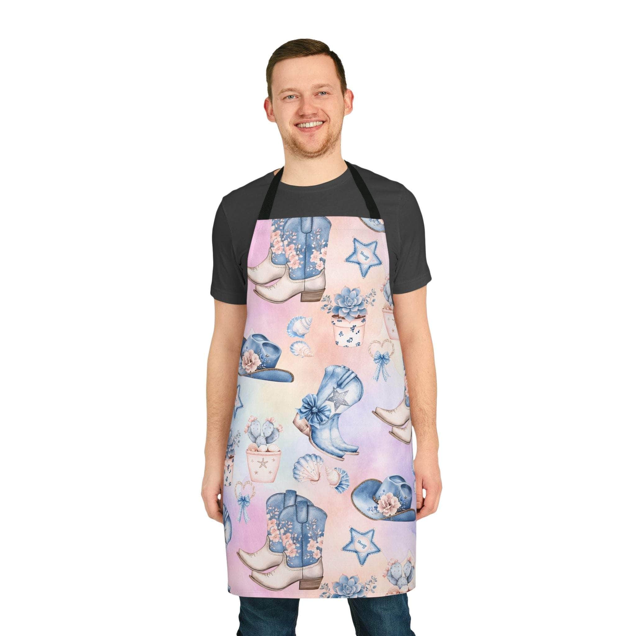 Pastel Coastal Cowgirl apron with beach-themed prints and black neck straps worn by smiling man