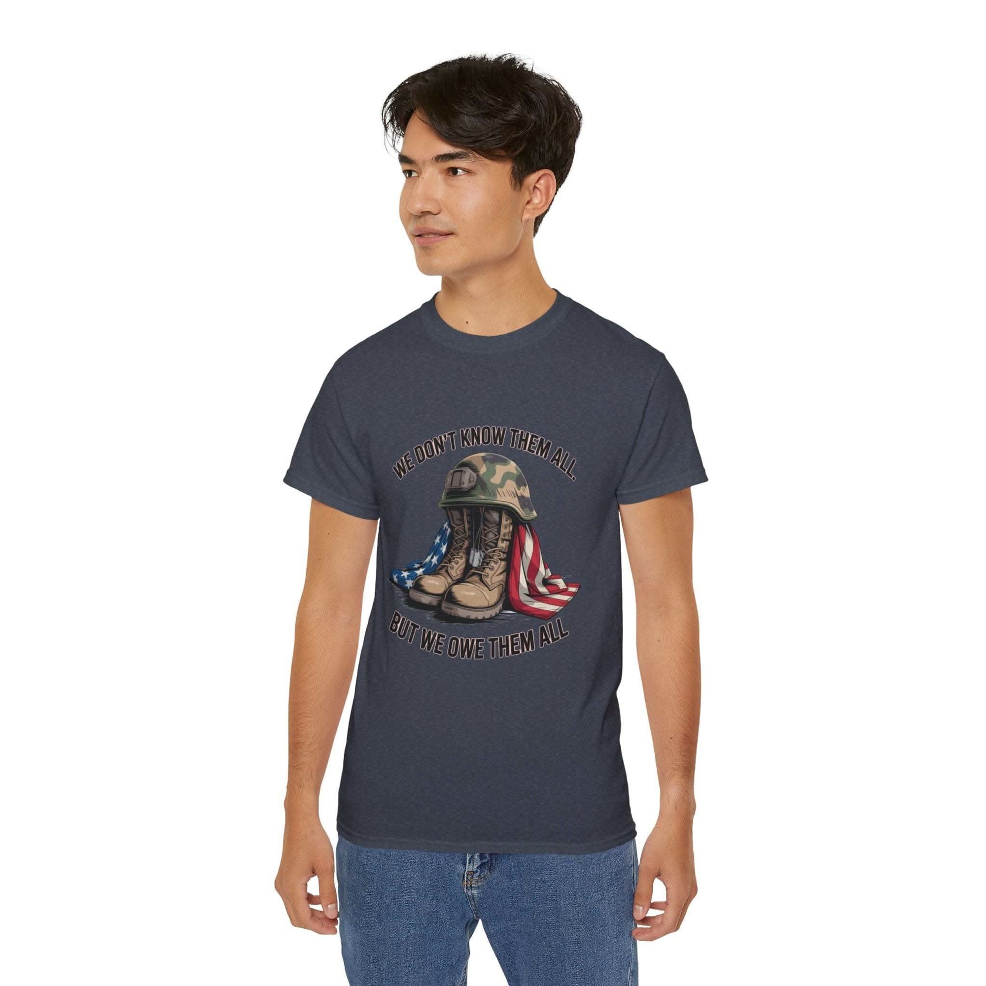 Unisex veteran T-shirt with "We Don’t Know Them All But We Owe Them All" message and patriotic design