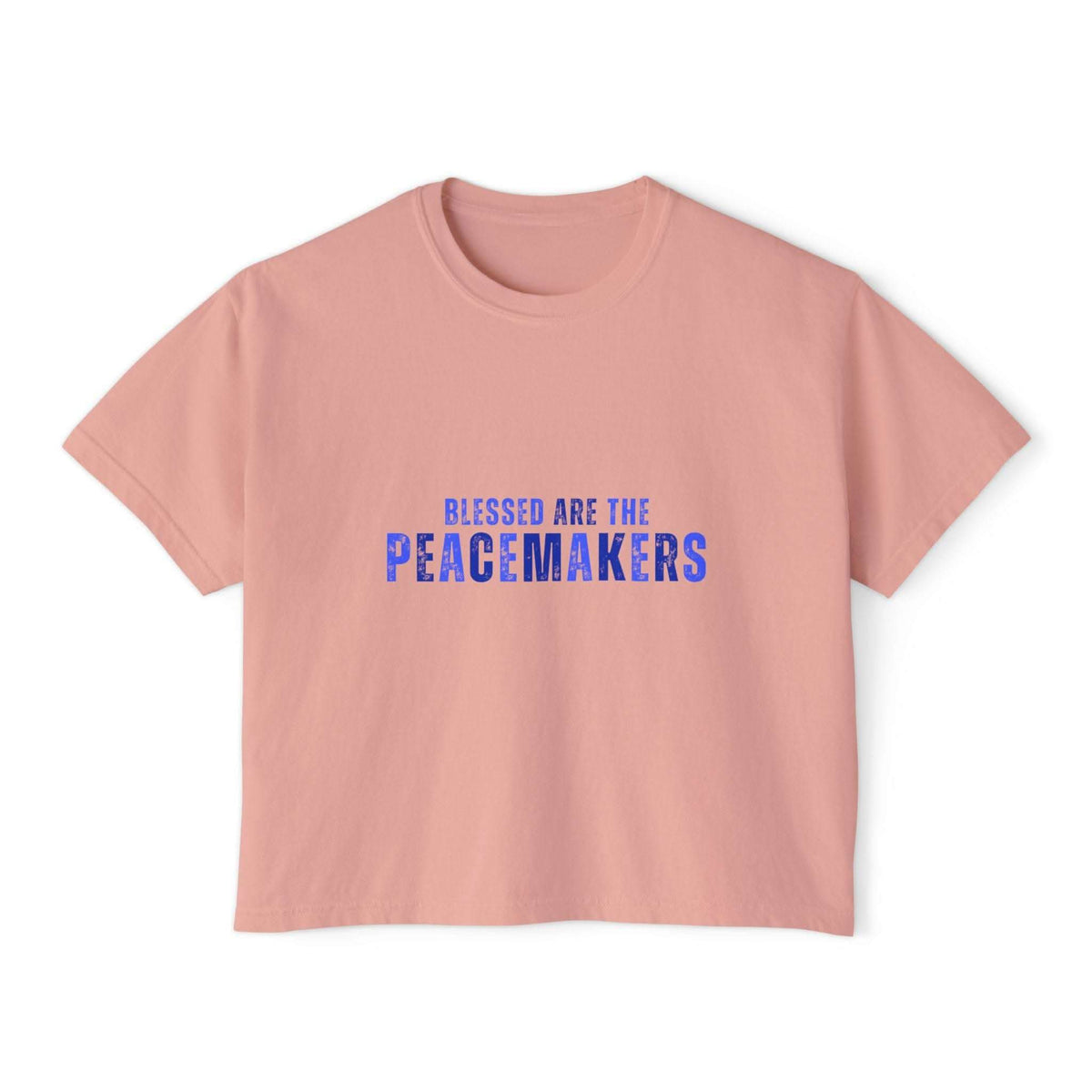 Women's boxy pink tee with "Blessed be the Peacemakers" text in blue, vintage style