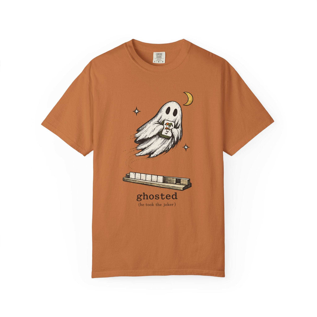 Flat lay of a yam orange mahjong T-shirt with a ghost holding a joker tile above a tile rack and “ghosted (he took the joker)” lettering.