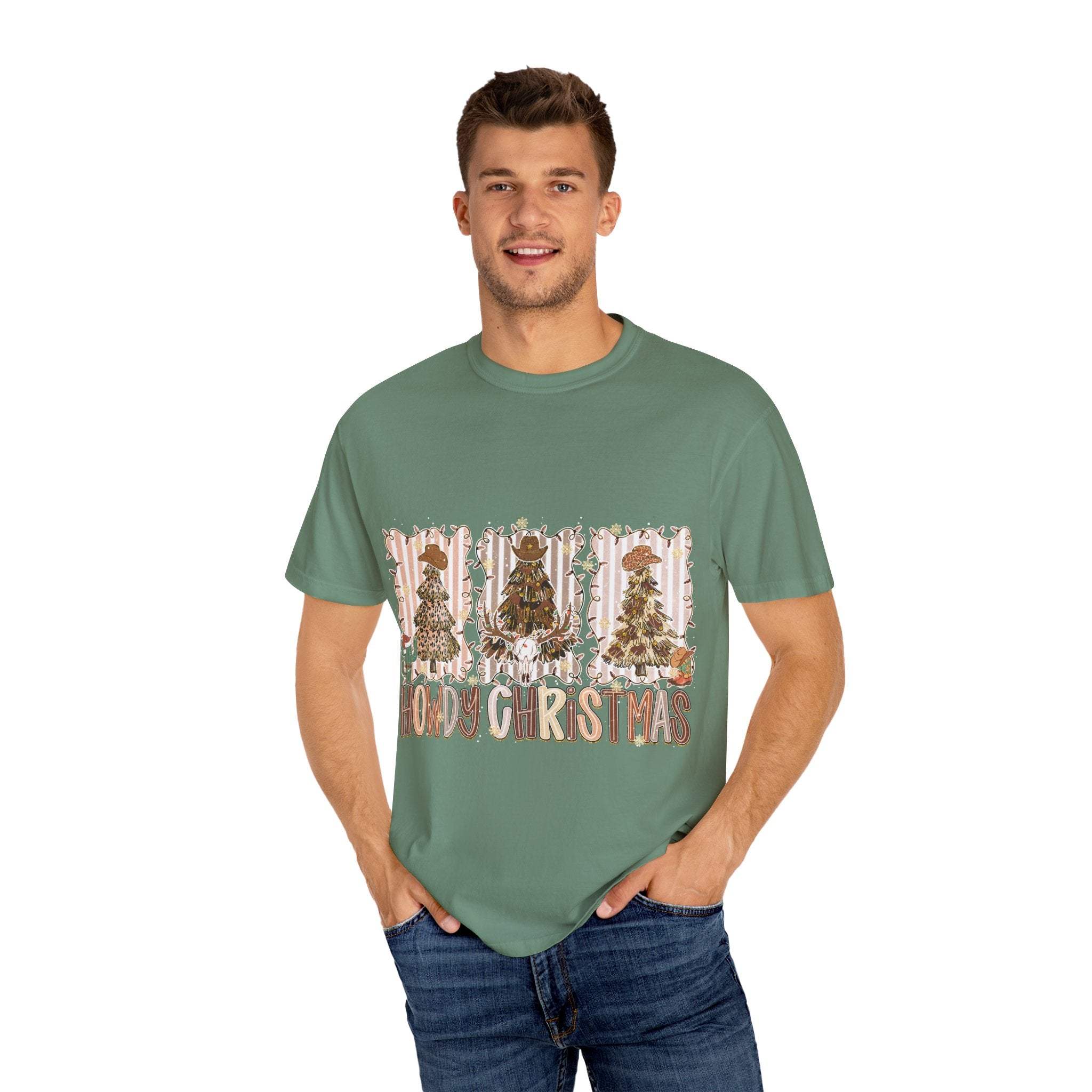 Cowboy Howdy Christmas t-shirt with festive cowboy tree design on green cotton fabric worn by smiling man