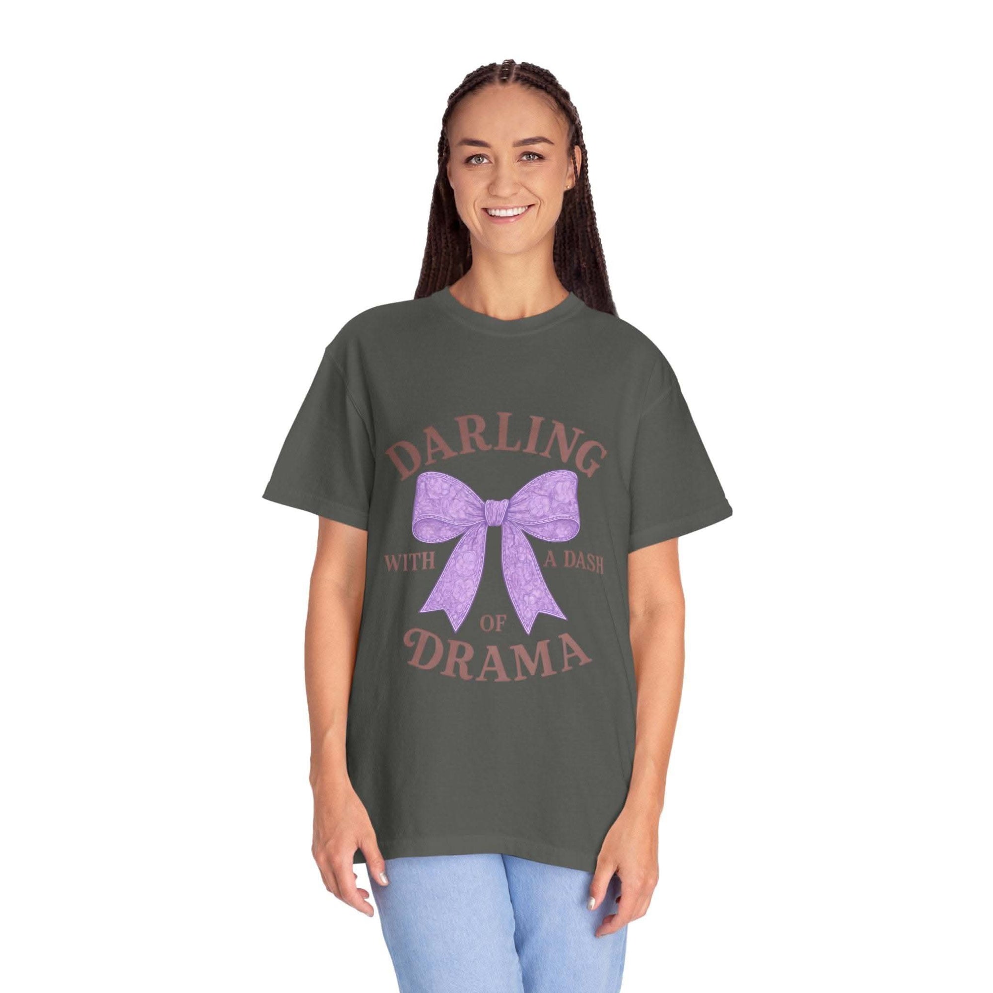 Woman wearing a dark gray t-shirt with a purple bow and text on a white background