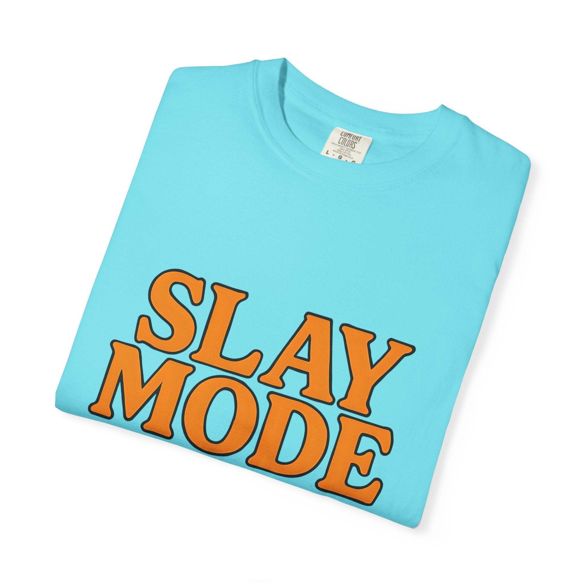 Light blue garment-dyed tee with bold orange "Slay Mode" text for confident casual wear