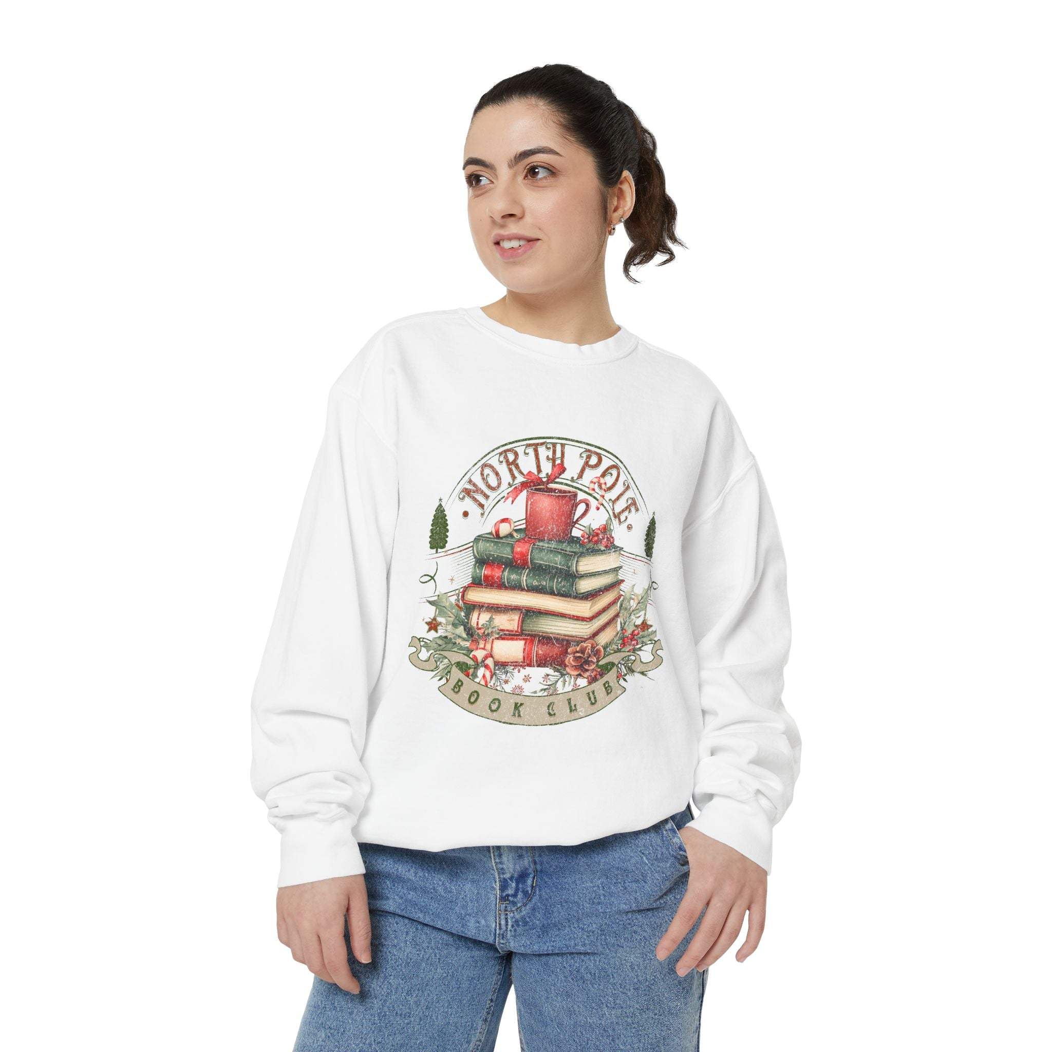 Woman wearing white Vintage North Pole Book Club sweatshirt with holiday-themed book stack design.