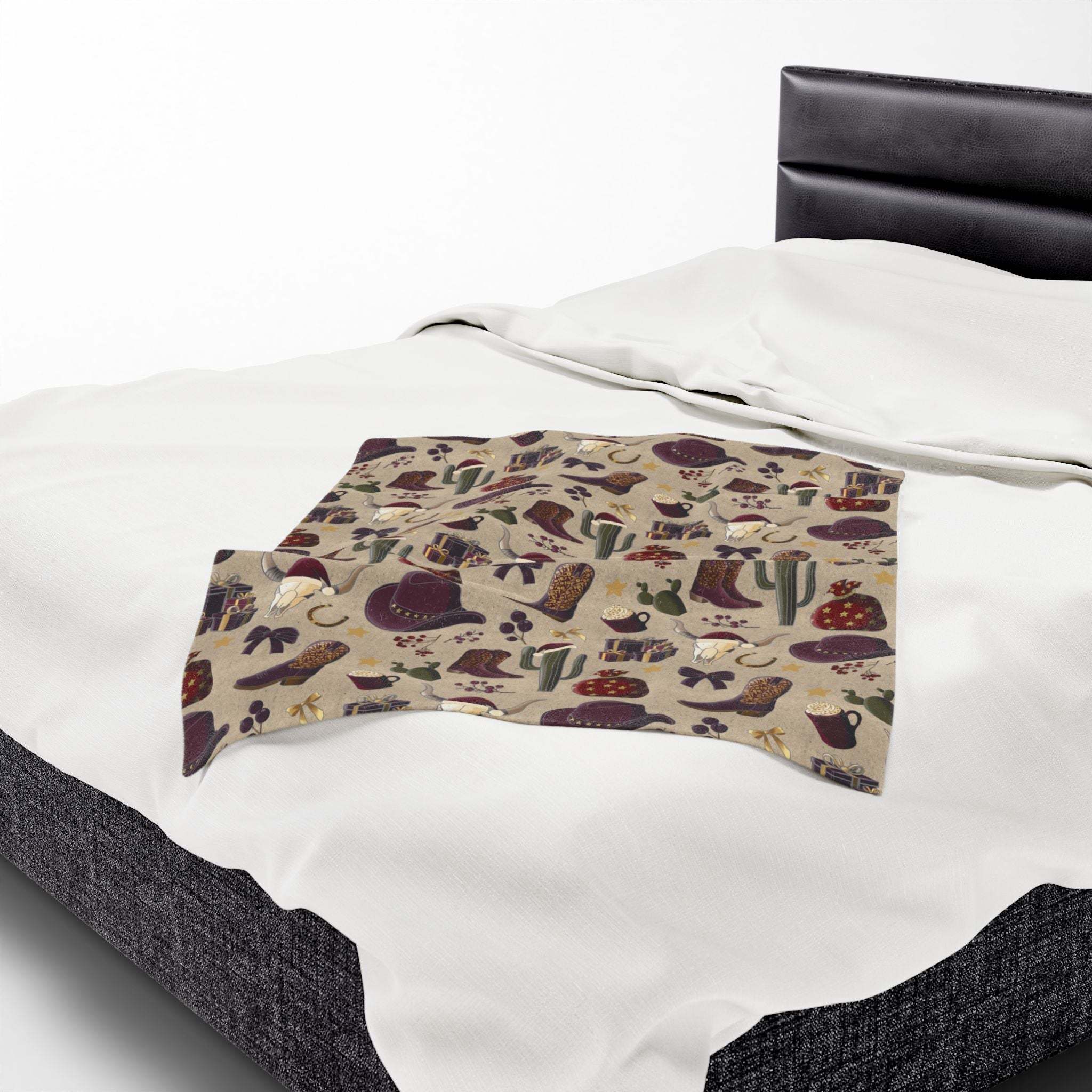 Plush blanket with Cowboy Christmas design on bed showcasing festive holiday theme and velveteen softness