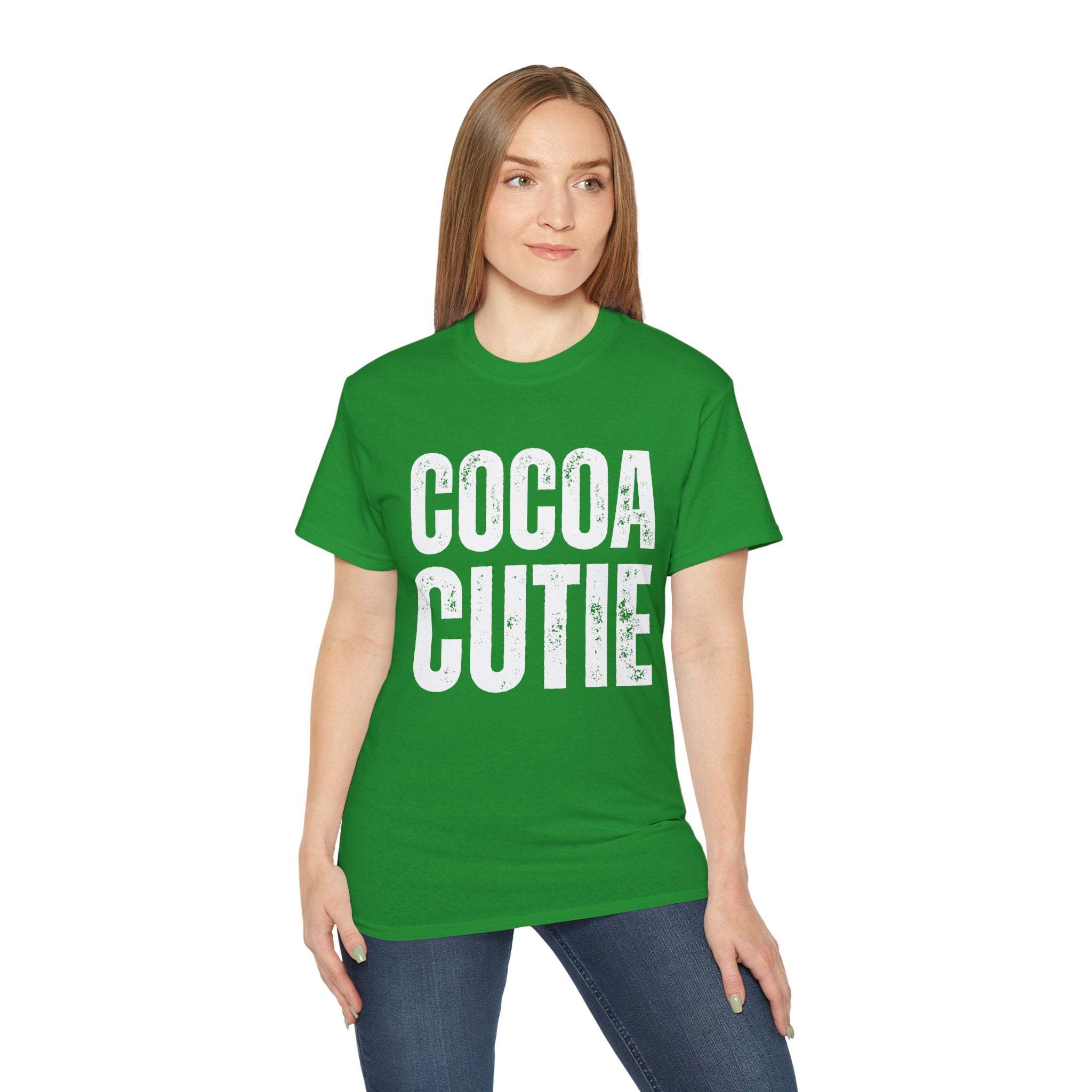 woman wearing green distressed Cocoa Cutie Tee with white text