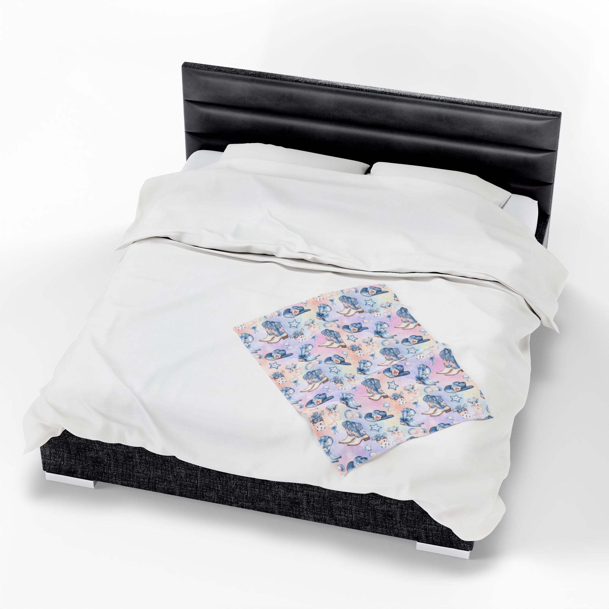 Coastal Cowgirl plush blanket with beach and horse design on bed