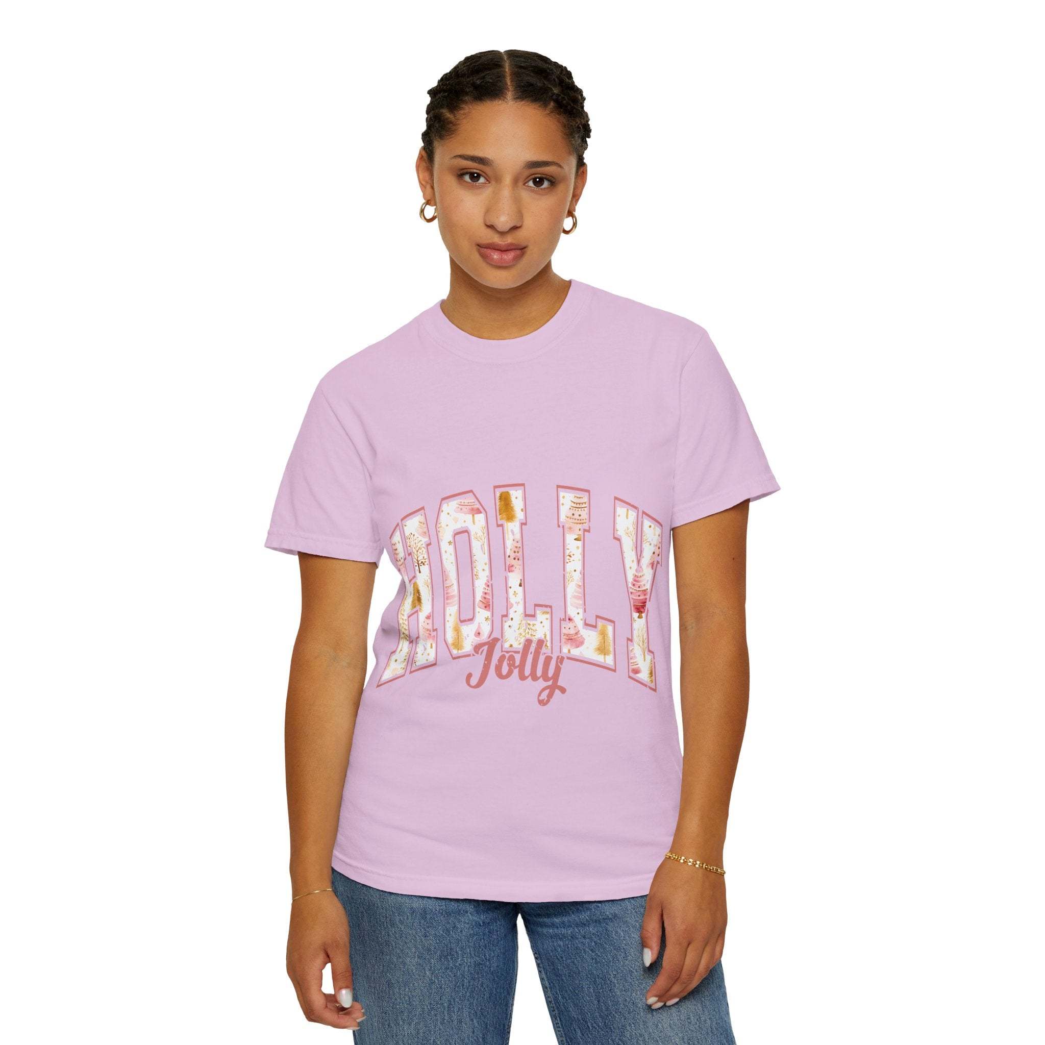 Woman wearing a pink Varsity Holly Jolly T-shirt with festive lettering and relaxed fit
