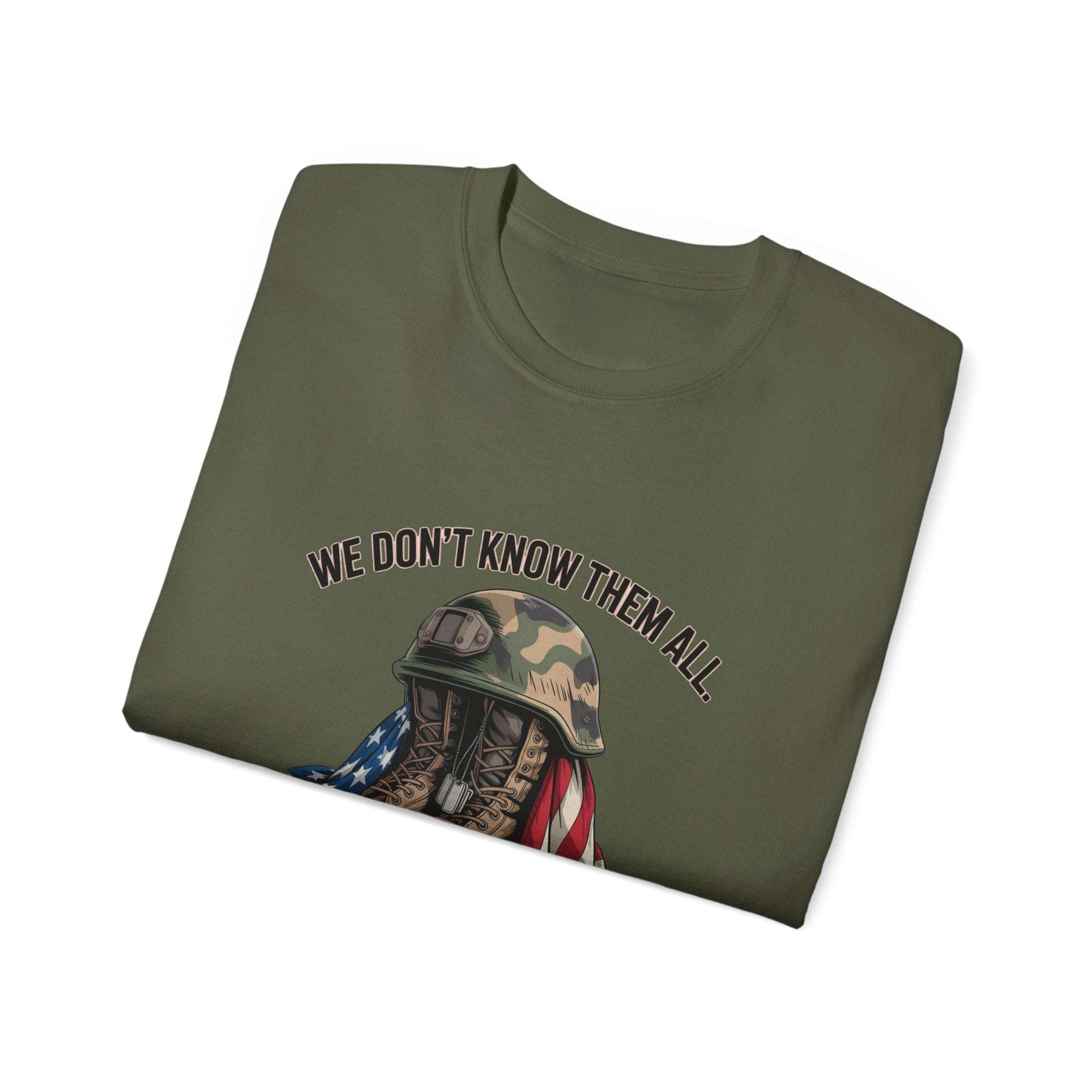 Folded olive green unisex T-shirt with veteran tribute text and military helmet graphic
