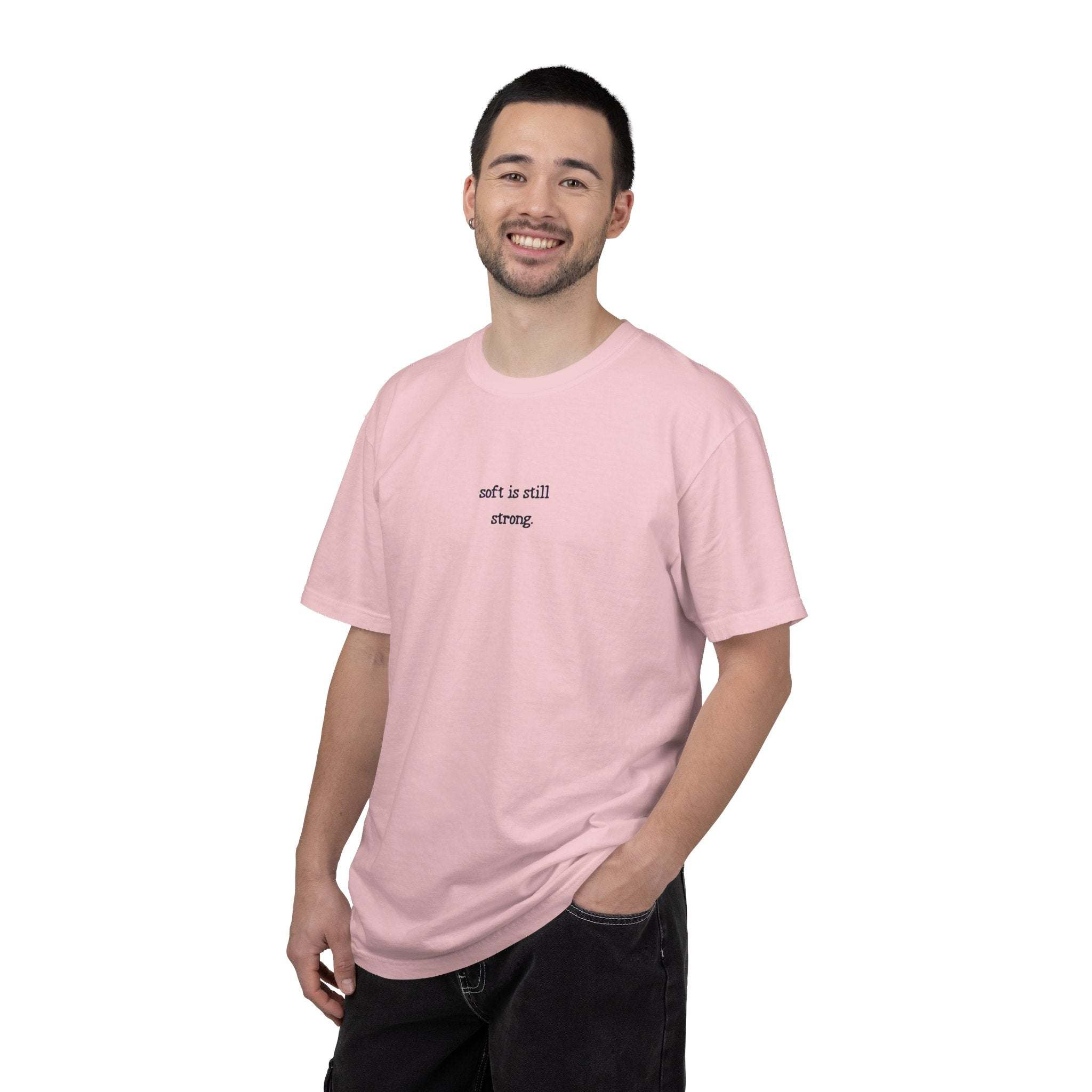 Man wearing a pink t-shirt with text on a white background