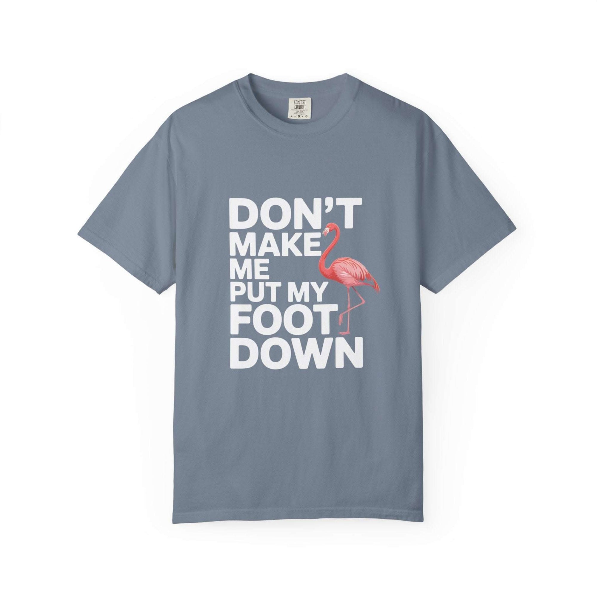 Dont Make Me Put My Foot Down flamingo T-shirt with bold white text and pink flamingo graphic on vintage garment-dyed cotton fabric