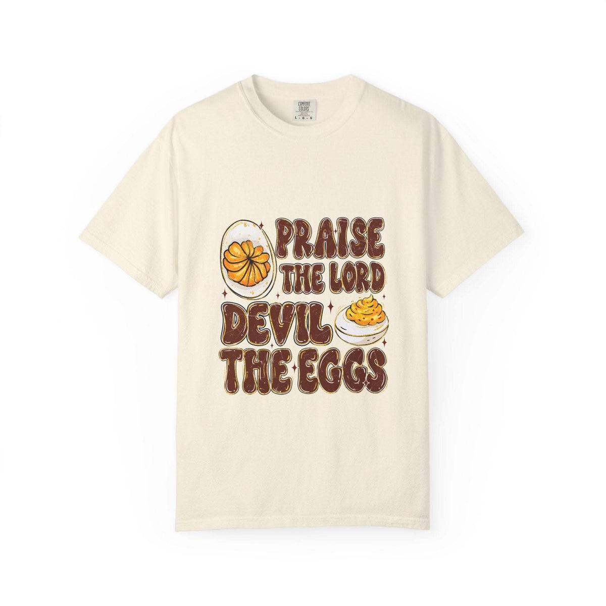 White Christian-themed t-shirt featuring 'Praise the Lord, Devil the Eggs' text design, available in sizes S, M, and L.