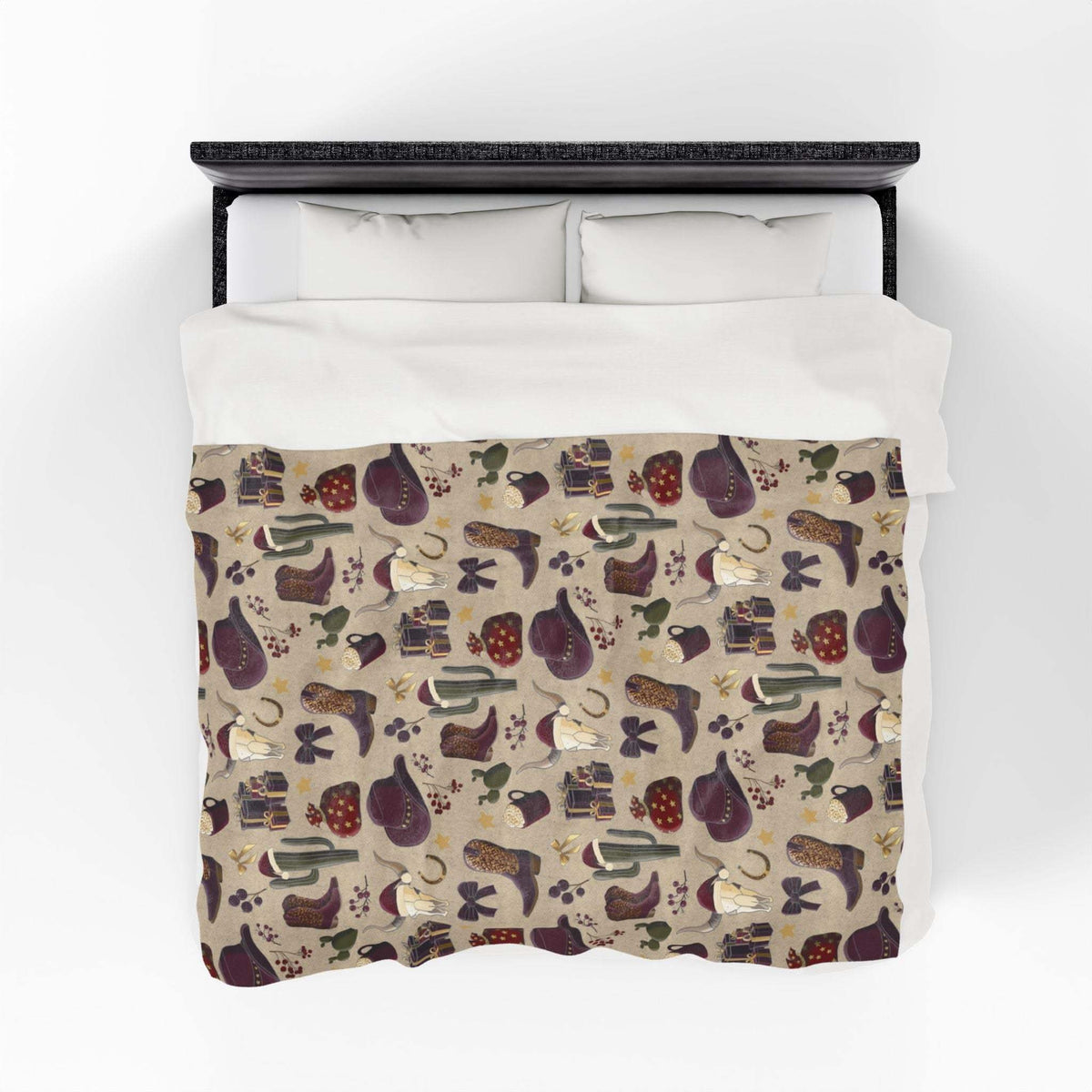 Cowboy Christmas themed plush blanket with festive Western pattern on bed