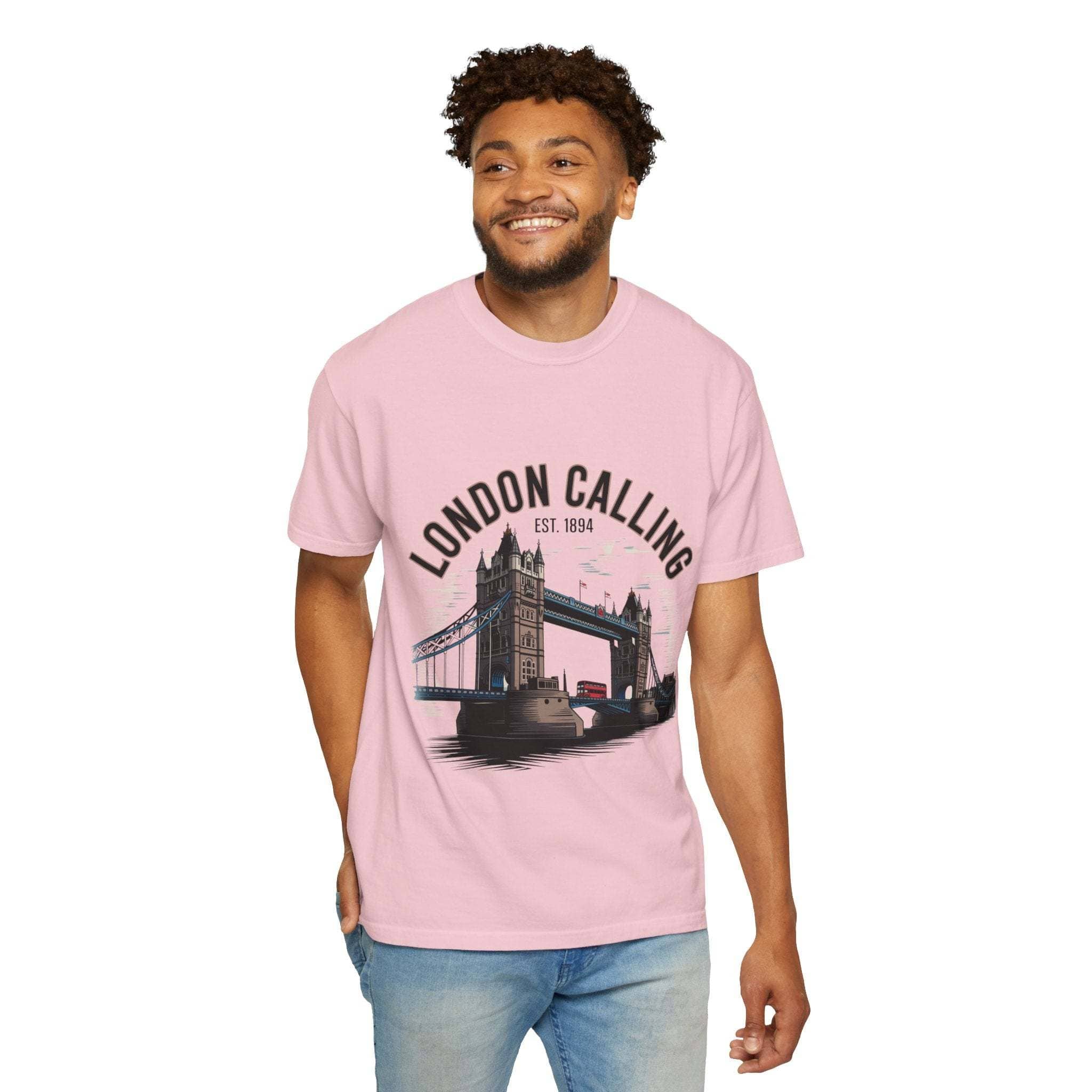 Man wearing pink London Calling Travel T-shirt with Tower Bridge graphic and blue jeans