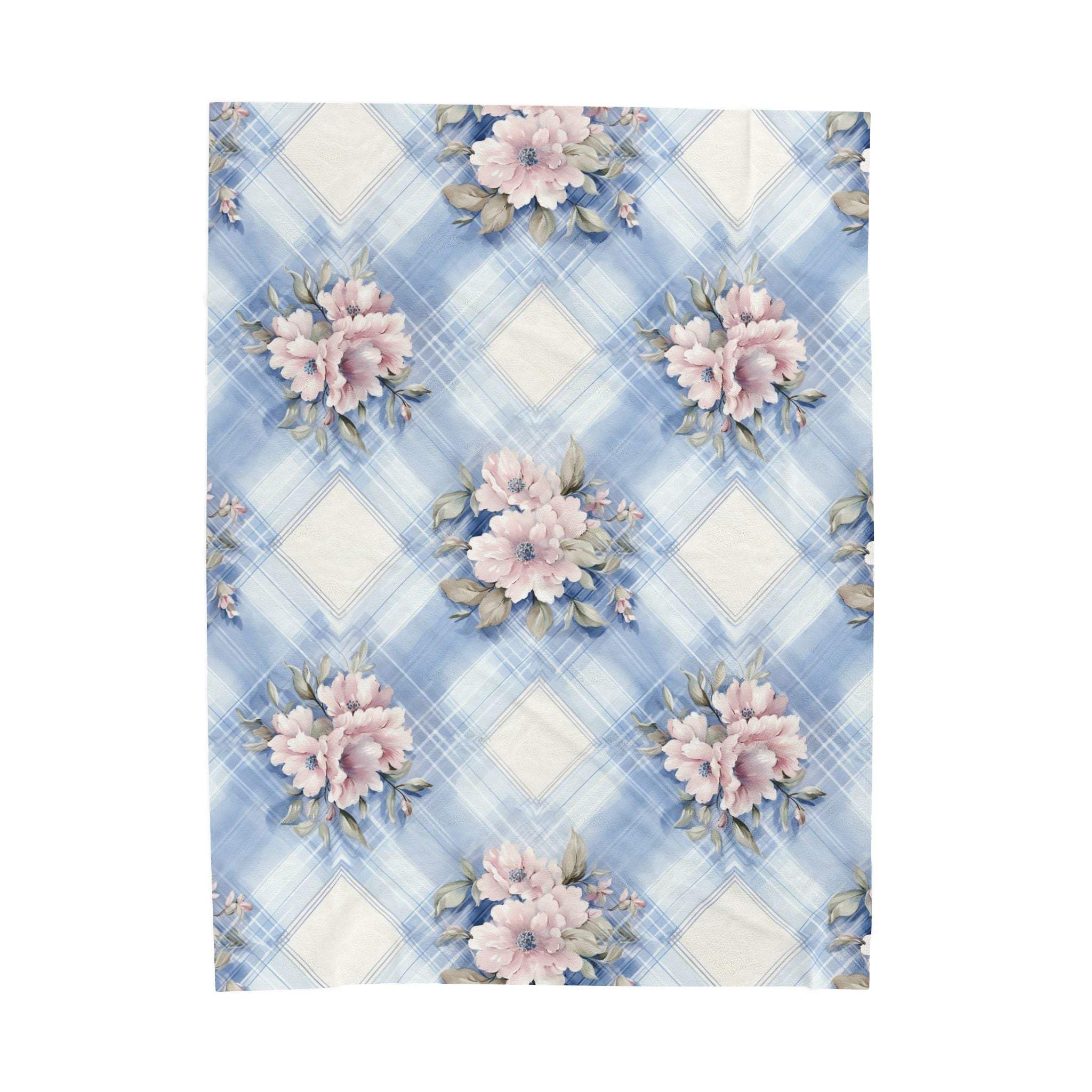 Velveteen plush blanket in pastel light blue and pink floral design, perfect for cozy bedroom decor.