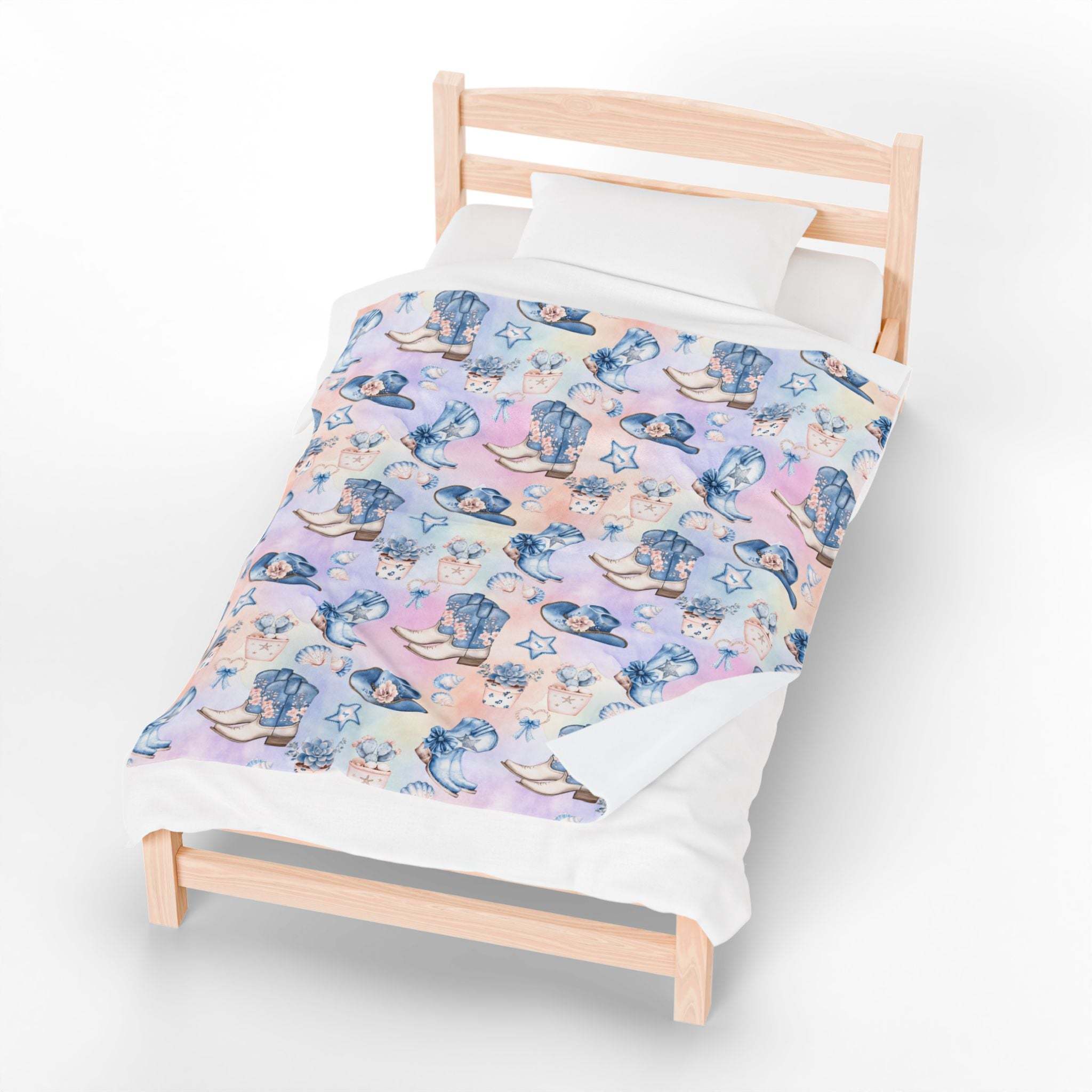 Coastal Cowgirl plush blanket with beach and horse design on bed