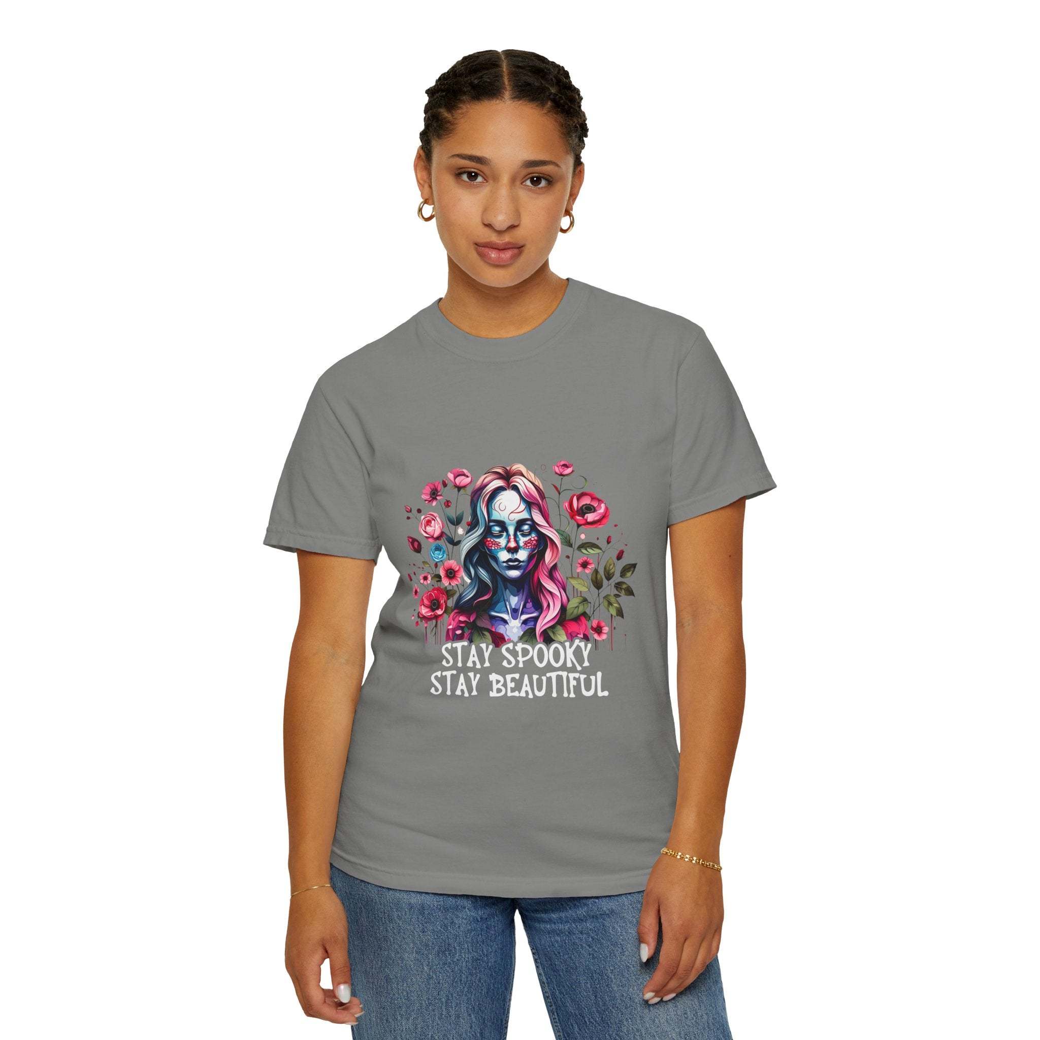Woman wearing gray floral skeleton t-shirt with "Stay Spooky Stay Beautiful" text and floral design