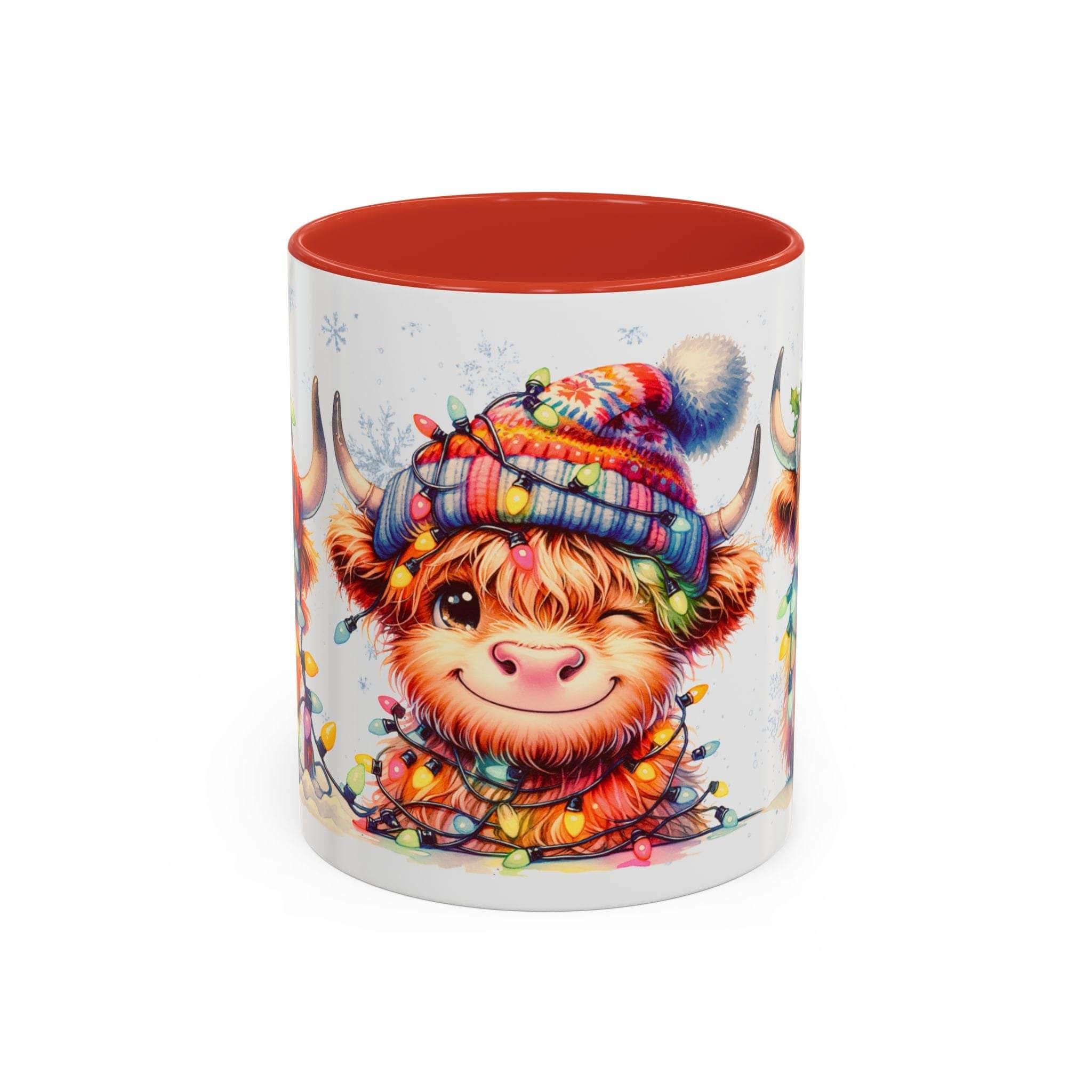 Ceramic coffee mug with colorful Scottish Highland Cow in winter hat and holiday lights, red interior and handle.
