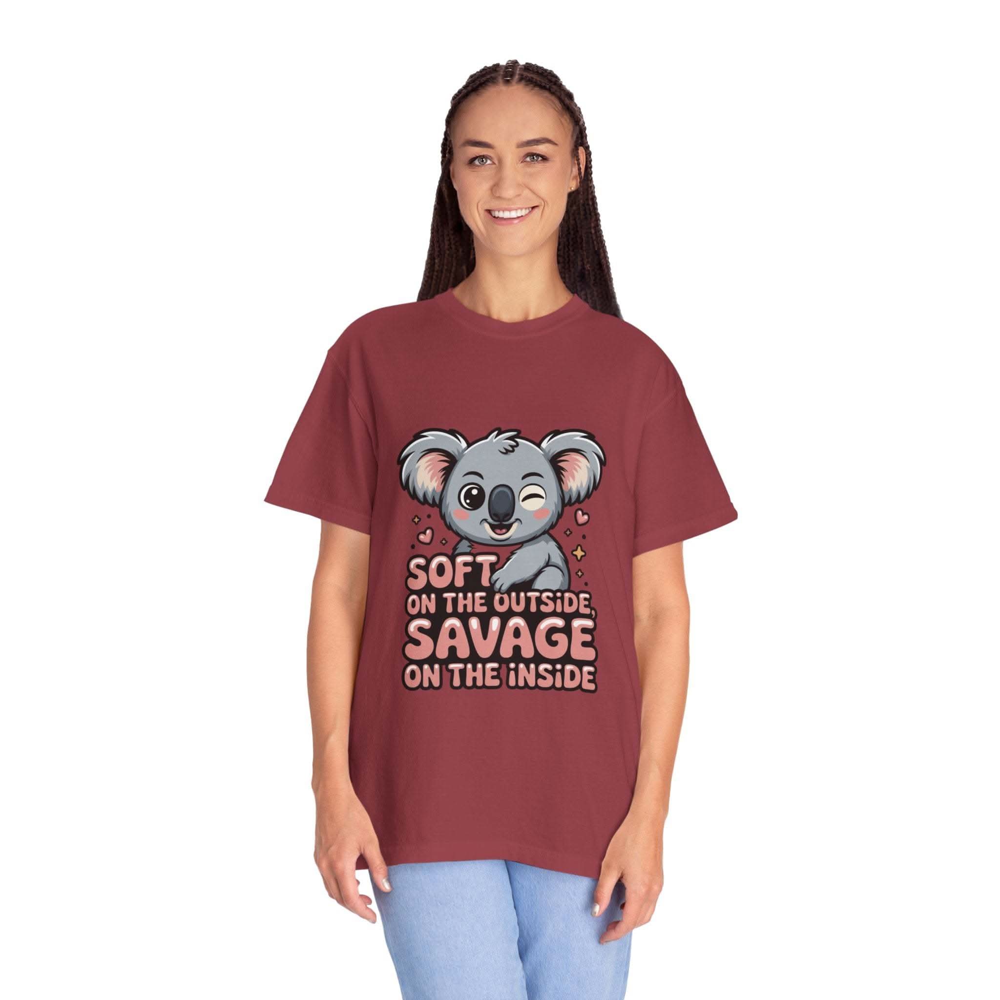 Woman wearing maroon t-shirt with playful koala graphic and "Soft on the Outside, Savage on the Inside" text