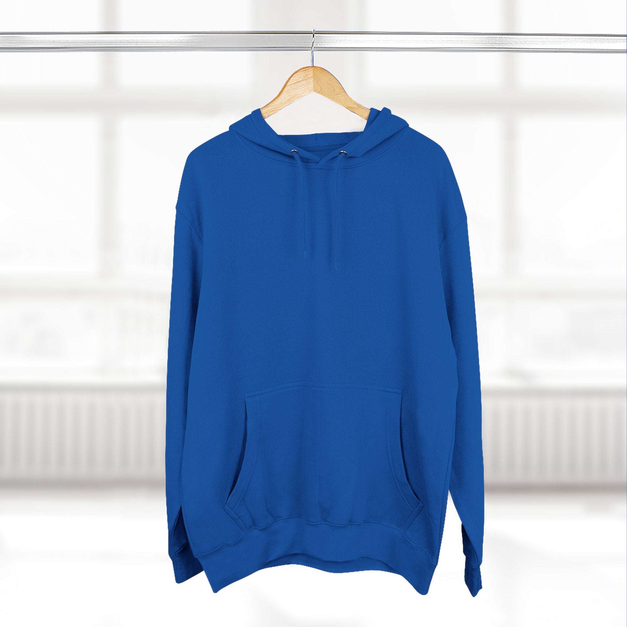 Blue fleece hoodie with adjustable hood and kangaroo pocket hanging on wooden hanger