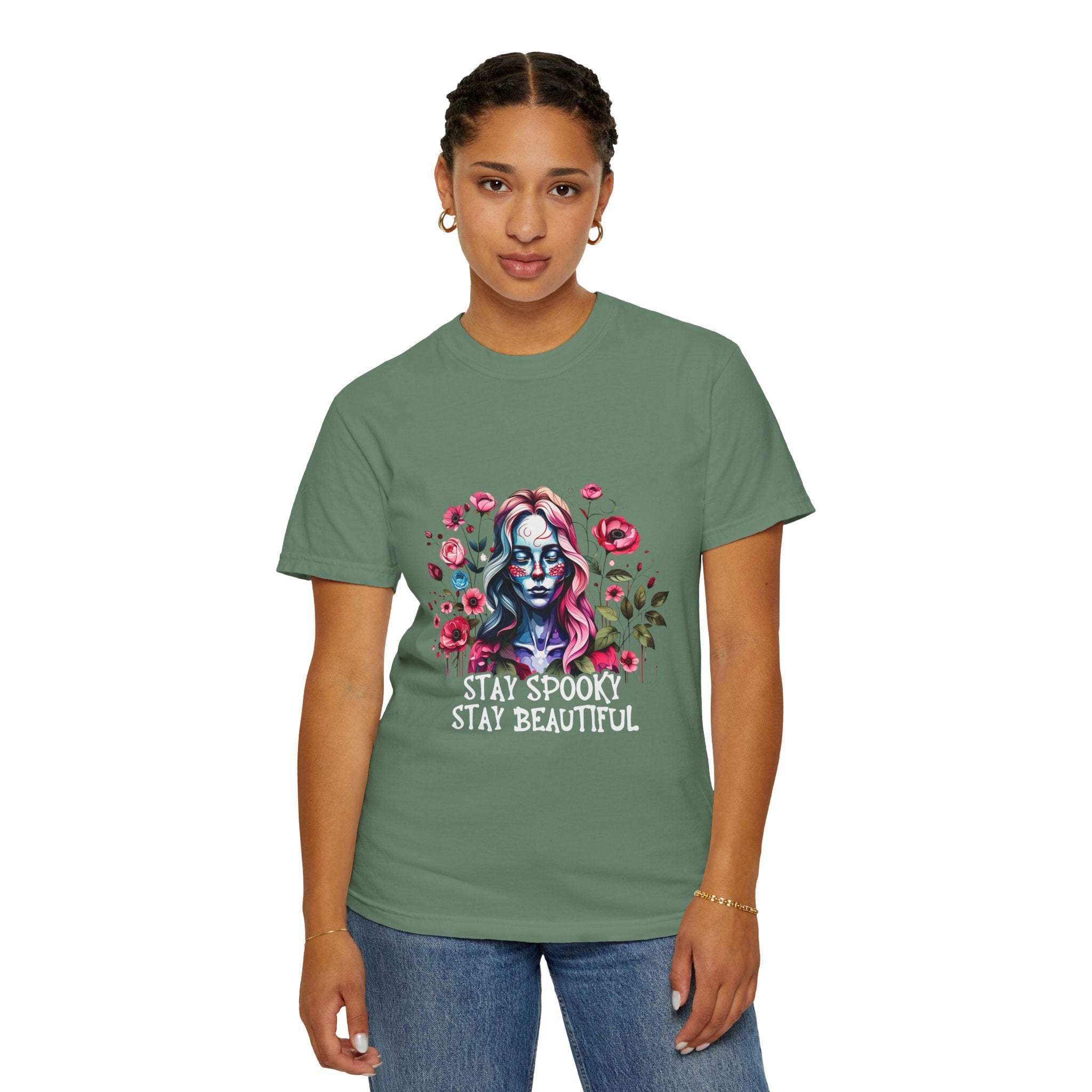 Woman wearing green floral skeleton t-shirt with "Stay Spooky Stay Beautiful" text and pink flowers design
