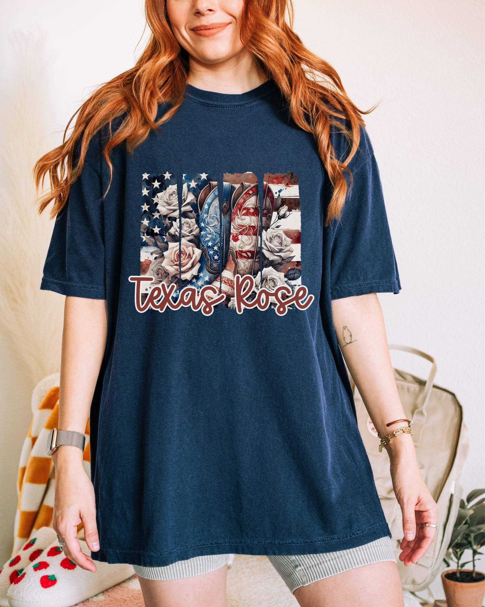 Woman wearing navy Texas Rose T-Shirt with floral and American flag design