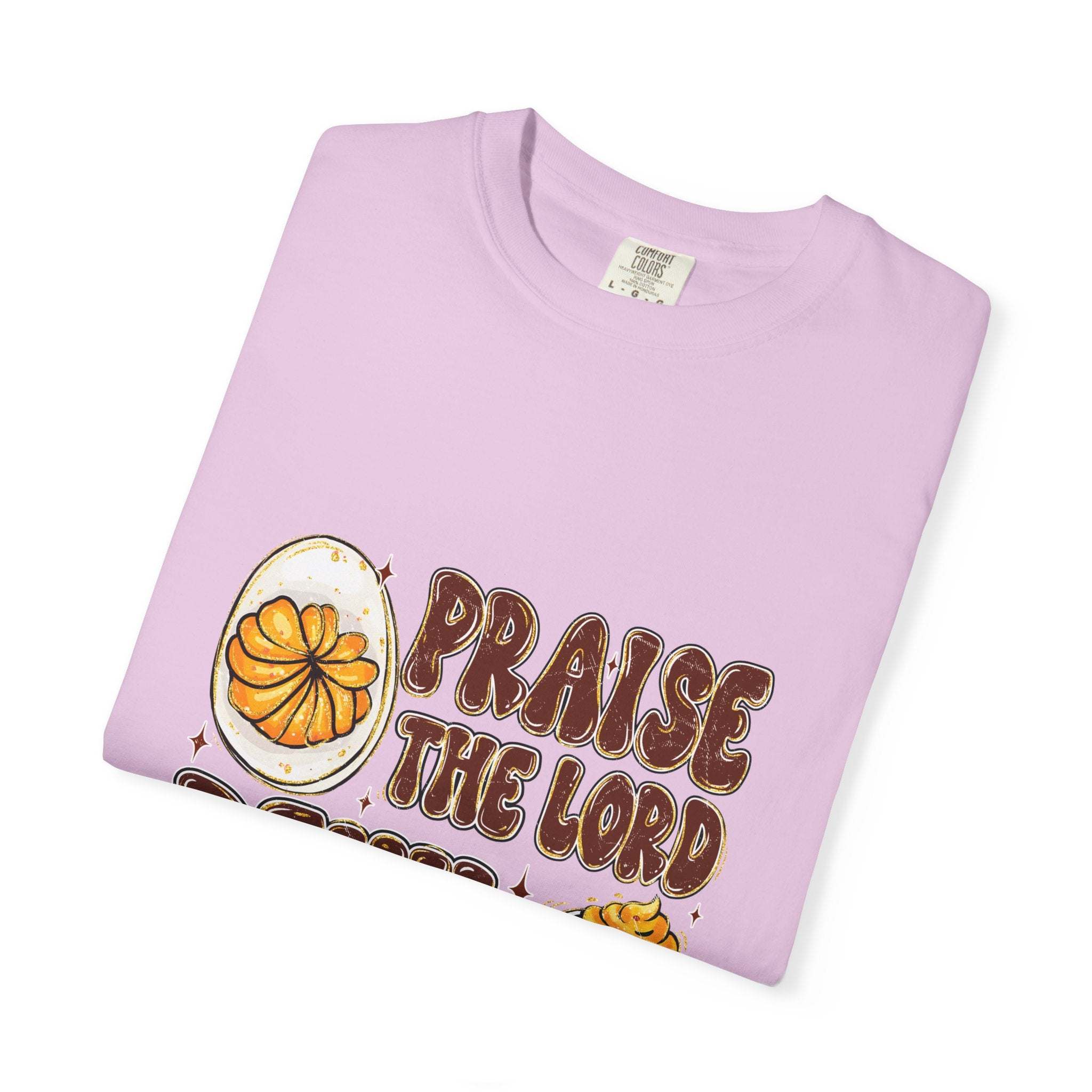 White cotton t-shirt featuring 'Praise the Lord, Devil the Eggs' design, perfect for Easter and Christian apparel.