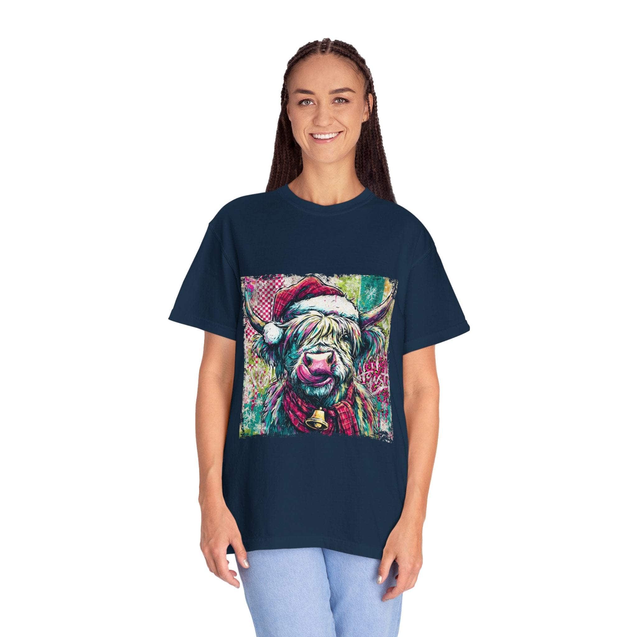 Woman wearing navy Retro Santa Highland Cow T-shirt with festive cow graphic in Santa hat and scarf