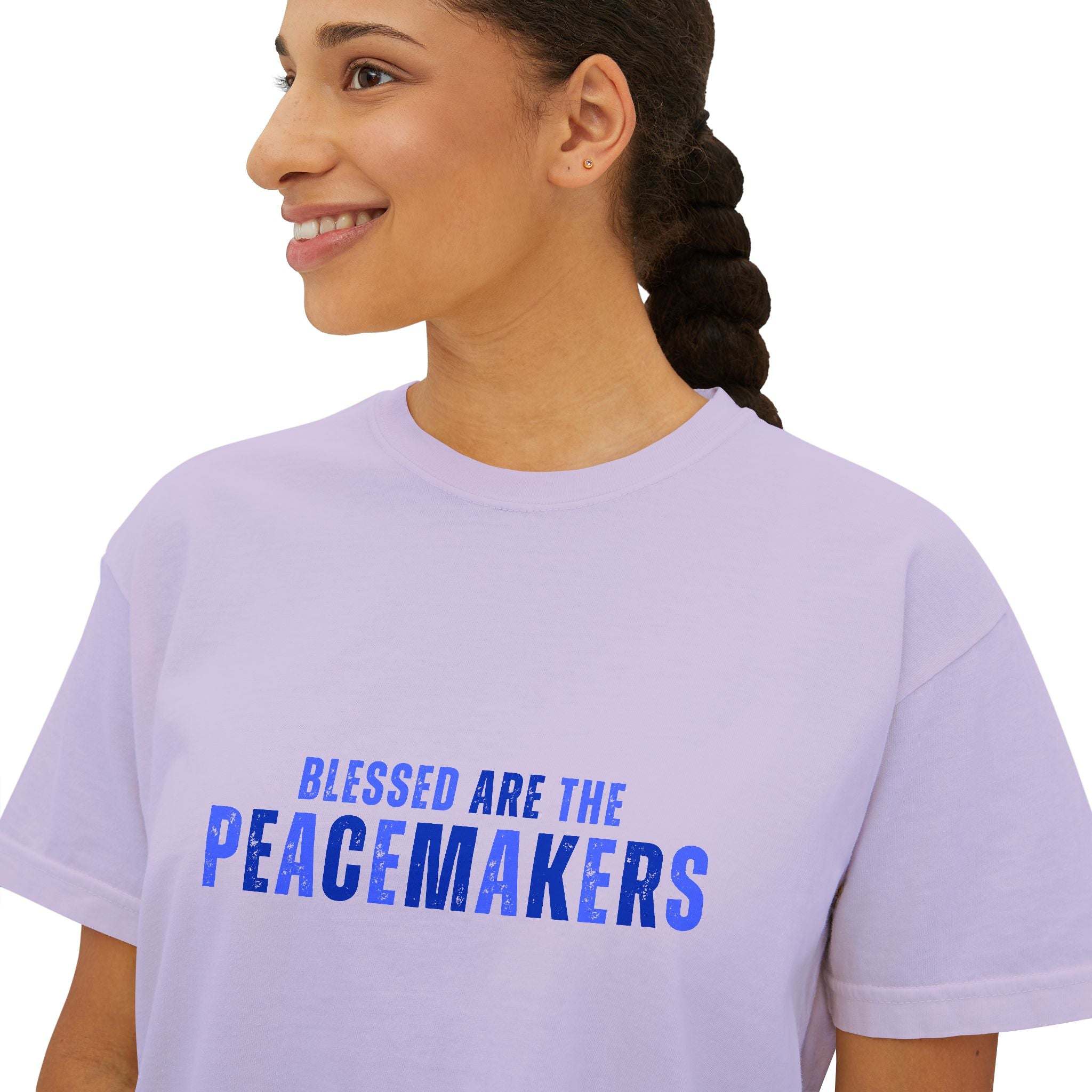 Woman wearing lavender Tee Blessed be the Peacemakers boxy shirt with blue text print