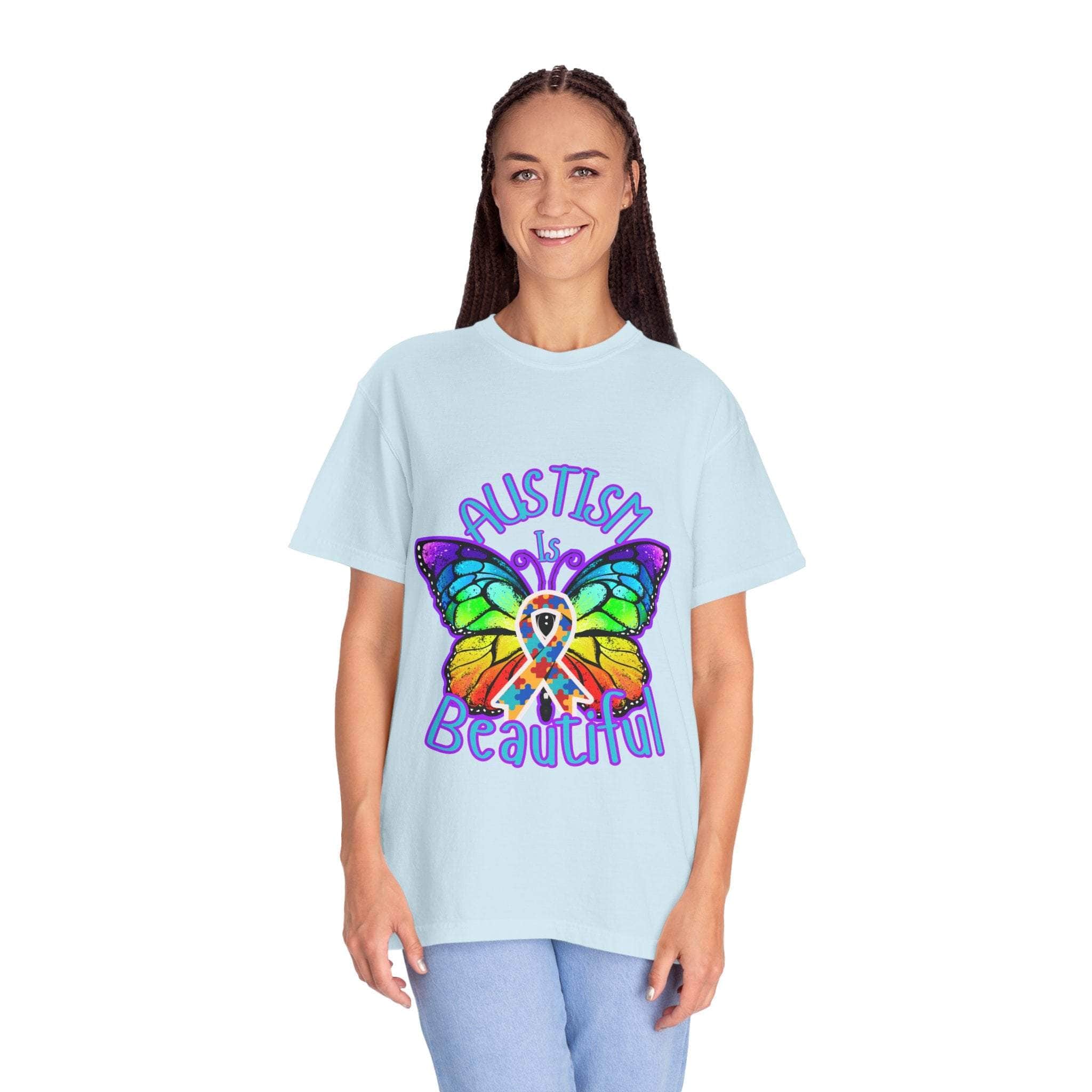 Woman wearing light blue Autism is Beautiful T-shirt with colorful butterfly design promoting autism awareness and acceptance
