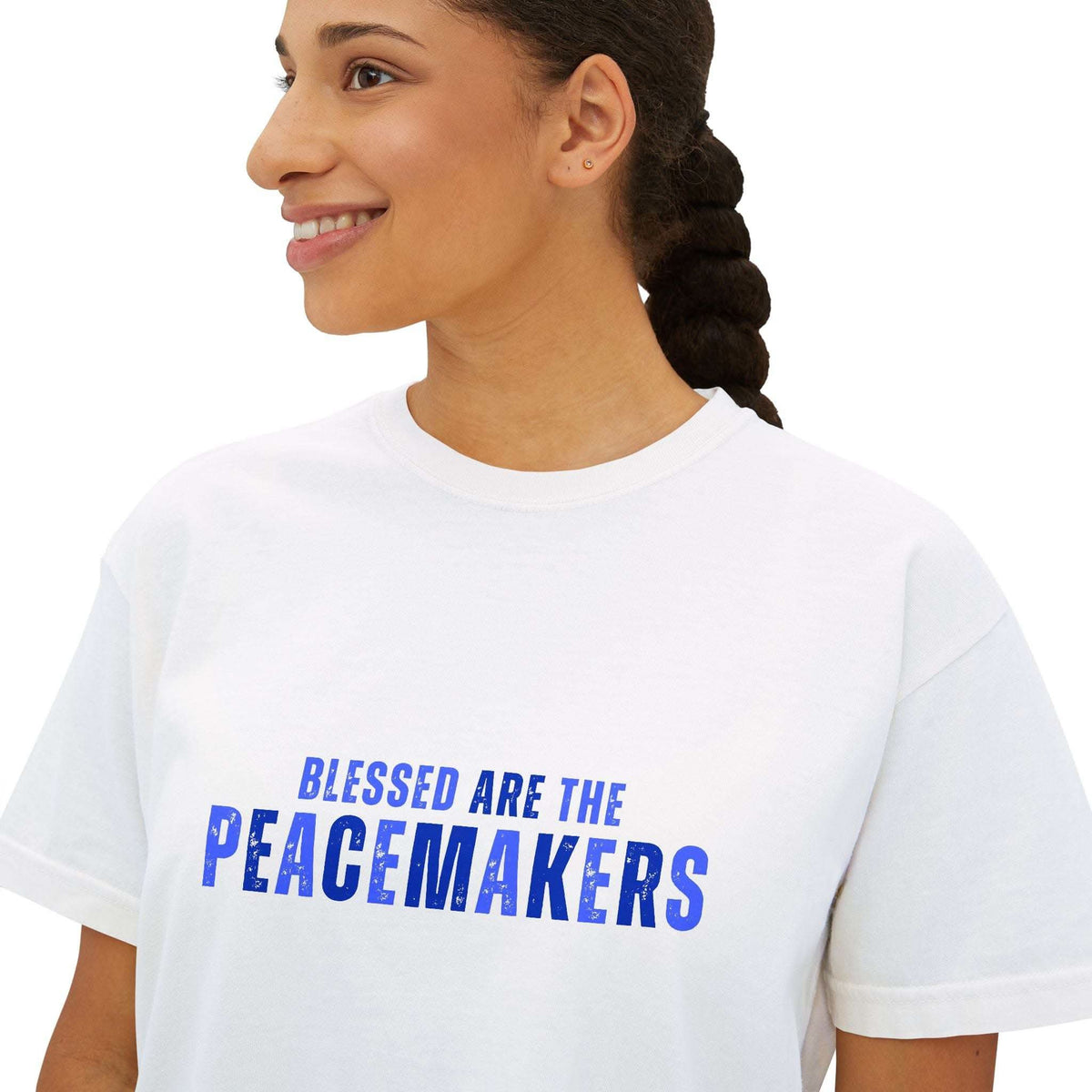 Woman wearing white Tee Blessed be the Peacemakers with blue text, boxy fit, casual positive message shirt